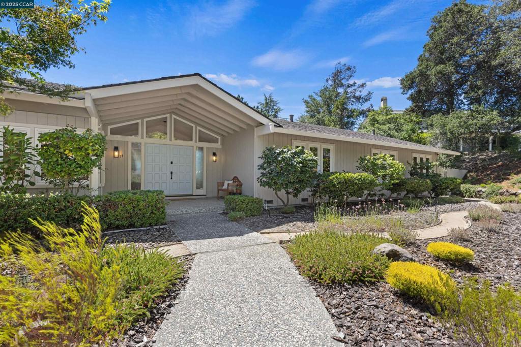 Beautiful single-level home on a fabulous third- acre offering a welcoming place to call home w/ a dramatic view of the picturesque chapel bell tower on the St.Mary’s College against a backdrop of Moraga’s Hills. Located in prestigious Bluff’s neighborhood w/ privacy & a peaceful setting. Andersen sliding French doors open to an amazing, ultra-private outdoor sanctuary where you can enjoy the incredible views from the spacious brick patio w/ built-in bench seating under the pergola, on the trex deck, or relish the picturesque gardens. There is plenty of room to entertain on every scale, play & relax. Behind the front garden, an inviting porch & double door entry is an open, light-filled floorplan. A wall of windows echoes the pitch of the vaulted ceiling in the formal living room featuring fireplace & hardwood floors. The bright kitchen enhanced w/ recess lighting, tile counters, plus a large breakfast room w/ built-in cabinetry & adjacent to a mud room & powder room. “Enjoy the view from the window over the sink” plus the wonderful great room for quiet evening, family fun or larger entertaining. A rare combination of amazing yard, beautiful house, top schools & desirable Bluff’s location!