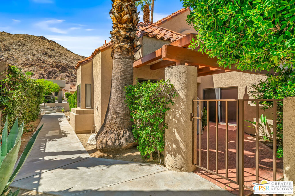 Palm Springs 2 bedroom 3 bath Townhouse in South Palm Springs on FEE LAND (no lease) surrounded by stunning mountain views. 1812 square feet of spacious living on two levels features; private entry gated courtyard, and extra large gated rea patio, living room with fireplace, wet bar, dining area, kitchen with breakfast area, dual suites- suite 1 is downstairs/main level with walk-in closet, double-vanity, soaking tub and stall shower, upstairs 2nd suite, vaulted ceilings, bath with shower. Generous size rooms, loads of storage space and updated kitchen, ceramic tile flooring in common areas. The Canyon Heights community offers stunning panoramic views of the surrounding desert landscape and is known for its natural beauty, tranquility, and upscale living. Amenities include gated resort style living with four pool/spas, tennis and pickle-ball courts, clubhouse, fitness room, putting green, dog park, direct access to the Lykken Hiking Trail & the Oswit Canyon Preserve. Two championship golf courses nearby, & minutes to downtown Palm Springs. Perfect Palm Springs lifestyle property, on Fee land (NO LEASE), very reasonable HOA's, and a well maintained community. This unit is sold furnished as shown.