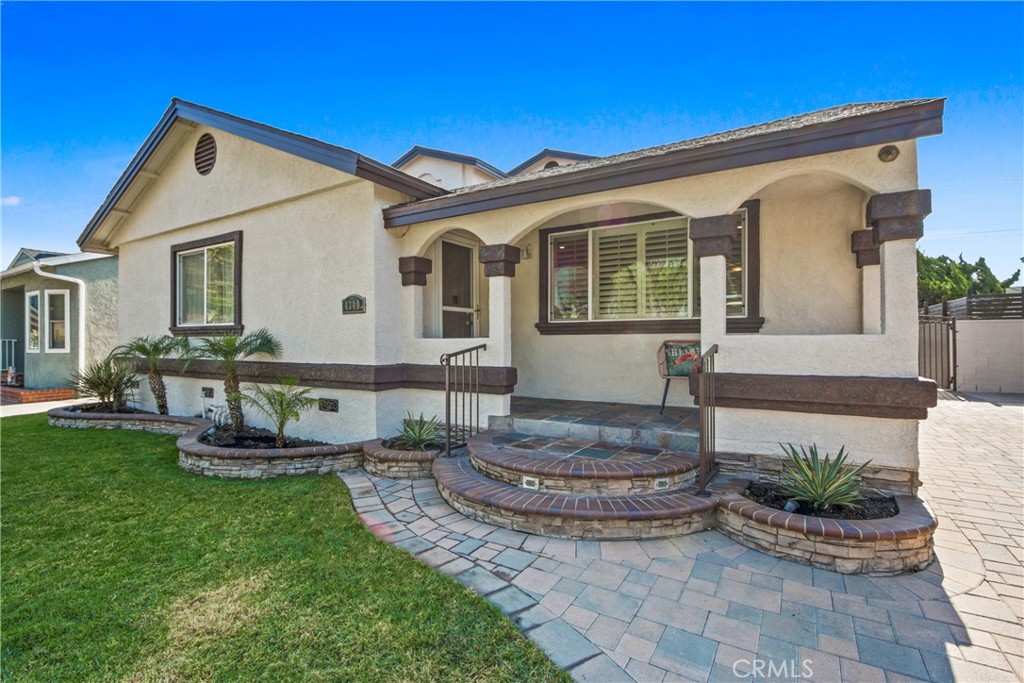 Nestled on a peaceful, tree-lined street, this beautifully updated 5-bedroom, 3-bath home offers comfort, style, and space in the sought-after Lakewood Mutuals neighborhood. Step inside to find new laminate flooring, fresh interior and exterior paint, smooth ceilings, and custom wood shutters that add timeless charm. The open layout features a welcoming living room, a large dining area, and a bright kitchen with white cabinetry, new quartz countertops & stainless steel appliances, and a walk-in pantry. The main level includes three bedrooms and two full baths, including a spacious primary suite with three closets (one walk-in) and a spa-like bath with dual sinks, walk-in shower, and jetted tub. Upstairs, two additional bedrooms and a full bath with walk-in shower provide flexible living space. The backyard is a private oasis with pavers that match seamlessly with the driveway making an expansive area that is perfect for entertaining day or night with ambient lighting, turf play area, and relaxing swim spa. Additional features include central heat and A/C, indoor laundry, and parking for up to 6 cars with a detached 2-car garage and long driveway. Close to Lakewood Country Club, Bixby Knolls, and Long Beach Exchange (LBX), this home offers both tranquility and prime access to shopping, dining, and entertainment.