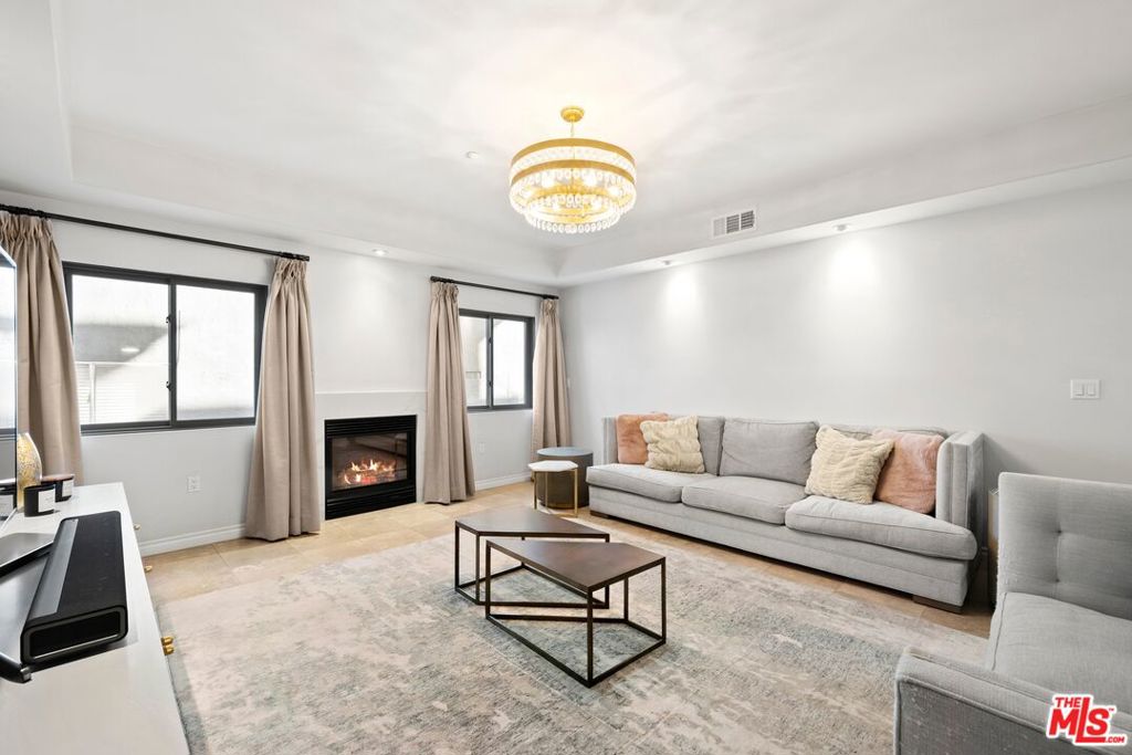 This delightful, fully furnished luxury condominium is positioned away from a tree-lined cul-de-sac street, offering a sense of calm in a boutique building in prime Brentwood. The stylish formal living room is appointed with an elegant chandelier, fireplace, and golden chevron accent wall. Tray ceilings in nearly every room add depth and dimension to each space, enhancing the home's feeling of peace, comfort, and solitude. The kitchen is beautifully updated with ample white cabinetry, bronze hardware, farm sink, and state-of-the-art appliances including Wolf range with hood and pot filler. A French door opens to a private covered balcony, perfect for al-fresco dining and relaxation, and there is also an adjacent eat-in area. Nearby, the foyer opens to the formal dining room which could also be utilized as a parlor or sitting room for tea and conversation. The primary bedroom is large and features an en-suite bath with dual-sink vanity and separate tub and shower as well as a walk-in closet with custom built-ins. There is also side-by-side laundry in unit and two tandem parking spaces with dedicated EV charger in the secure, controlled-access subterranean garage. Welcome to this excellent, coveted location amidst Brentwood's numerous fine restaurants, eateries, and boutiques, all just moments to Santa Monica beaches, Beverly Hills, freeways, and the very best of the Westside.