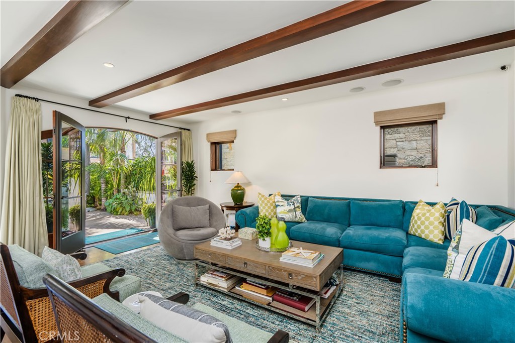 An exceptional South-facing walk street home, just two blocks from the beach and Downtown Manhattan Beach.
Fully furnished by Grace Home Furnishings, 321 9th Street offers 5 bedrooms, 4.5 bathrooms, and 4,159 square feet of thoughtfully designed living space. Positioned on a coveted flat walk street known for its community charm, the home enjoys ocean views, multiple outdoor spaces, and seamless indoor-outdoor flow.
The top level is ideal for entertaining, with an open-beamed living room, fireplace, wet bar, and French doors leading to a spacious outdoor lounge with a wood-burning fireplace. The chef’s kitchen features a large island, walk-in pantry, and professional-grade Viking appliances, while the adjacent breakfast nook and built-in BBQ balcony capture gorgeous south-facing views.
On the middle level, the primary suite includes a king-size bed, office/sitting area, spa-like bath with jetted tub, and walk-in closet. Three additional bedrooms complete this level—one with an en-suite bath, two sharing a hallway bath.
The lower level includes a generous guest suite with en-suite bath and an entertainment room that opens directly to the walk street patio—complete with dining area, fire pit, and lush landscaping.
Additional highlights: travertine and walnut flooring, 500-bottle wine cellar, outdoor shower, three-stop elevator, air conditioning, and a three-car garage (or two-car with gym setup).
Experience elevated coastal living just moments from the sand.
TERMS: Home comes furnished, utilities to be paid by tenant, available for a 12 month lease staring Sept.1, please inquire about dogs- no cats.
