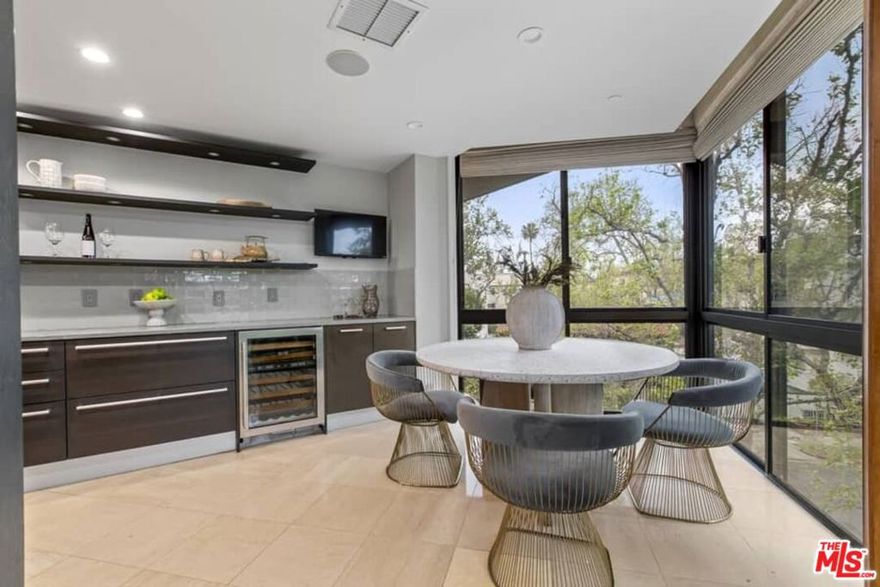 On a tranquil tree-lined street in prime Beverly Hills, this fabulous 2-bedroom plus den, spacious corner unit,offers modern amenities in the prestigious IV Seasons building. Featuring panoramic views of the Hollywood Hills, high-ceilings and loads of natural light, this unit has been thoughtfully appointed with high-end finishes and fixtures. Foyer entrance leads to a grand living and dining room flooded with naturallight and lined by a lovelyterrace overlooking Beverly hills. Custom cabinetry featuring imported wood is highlighted throughout. Primarysuite offers generousheight and volume including an ensuite custom walk-in closet, soaking tub and shower, double vanity sinks and water closets. Secondary bedroom features an ensuite bathroom. Multi-purpose den functions as a media room, office or lounge space and features in-unit laundry. The IV Seasons building offers magnificent amenities including 24/7 doormen, valet parking, a newly renovated pool and spa, gym and storage. Walking distance to shops and restaurants in Beverly Hills, Robertson Blvd. and Cedars Sinai, enjoy the perks of city living with the privacy and security only available in a building like the IV Seasons.