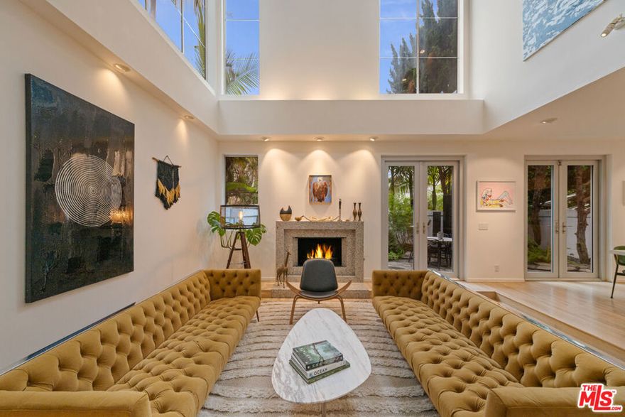 Welcome to 131 Mast Mall, a stunning gated residence blending modern luxury with timeless warmth. Remodeled in 2020, this beautifully crafted home features both rich oak hardwood and sleek bamboo flooring throughout, creating a sophisticated and inviting atmosphere. The main level offers an ideal layout for entertaining, showcasing a bright and elegant living room with a cozy fireplace, a dedicated dining area, and a chef-inspired kitchen. Designed for the culinary enthusiast, the kitchen boasts dual dishwashers, double ovens, and a large wine refrigerator, perfect for hosting gatherings of any size. Just beyond the main living spaces, a separate family room or den provides a comfortable retreat for relaxation or media enjoyment. Outdoors, a charming patio surrounded by fruit trees and a tranquil fountain creates a serene setting for alfresco dining. Additional conveniences include an EV charger in the garage, adding modern functionality to this thoughtfully designed home. On the second level, the spacious primary suite serves as a luxurious retreat, complete with its own fireplace and an enormous walk-in closet. The spa-like primary bathroom includes dual vanities, a soaking tub, a walk-in shower, and an expansive sauna that elevates everyday living. Two additional bedrooms on this floor provide comfortable accommodations for family or guests, accompanied by a full bathroom. The top level offers a versatile bonus room and adjoining bonus area, ideal for a loft, home office, studio, gym, play area, or even an unofficial 4th bedroom. Step outside onto the private rooftop deck and discover a true entertainer's paradise, featuring a built-in hot tub, a cozy fire pit, and ample space for hosting unforgettable gatherings under the stars. 131 Mast Mall is an exceptional property that blends comfort, luxury, and effortless coastal living, an extraordinary opportunity not to be missed.