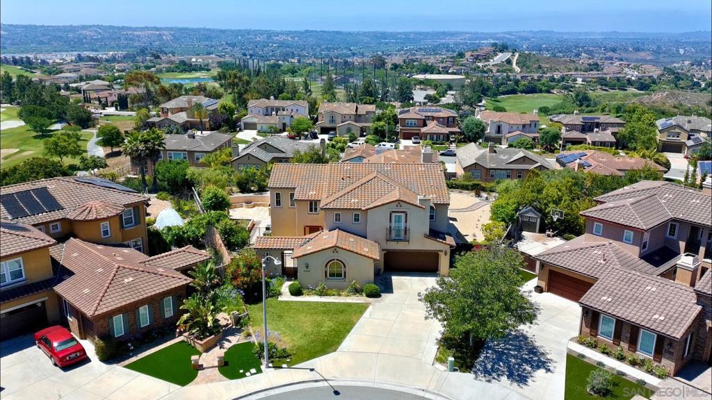 **PANORAMIC VIEWS**LARGE LOT**CUL-DE-SAC**OWNED SOLAR: Located in the Montemar neighborhood of Arrowood, this 4,159sqft, 5 bed / 4.5 bath home offers a rare blend of space, privacy, and sophistication. Features include engineered wood floors, arched entryways, high ceilings, and an open-concept kitchen with granite counters, a large island, and double ovens—seamlessly connected to the family room with fireplace and surround sound. The spacious primary suite captures panoramic views and includes two walk-in closets and a luxurious bath. The upstairs loft and primary suite both open to a shared view balcony. A first-floor ensuite bedroom adds flexibility for guests or multigenerational living. The backyard is designed for entertaining, with a built-in BBQ, gas fire pit, multiple pergolas, and low-maintenance landscaping—all overlooking a stunning natural backdrop. Enjoy resort- style living with Arrowood’s community pool, clubhouse, walking trails, and championship golf course. Bonsall School District. Welcome Home!