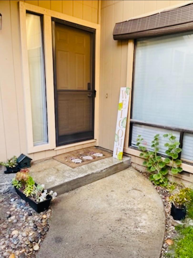 Welcome to this bright and airy end-unit townhome located in the desirable Morgan Village community. This well-maintained home features a private courtyard entry, a fenced rear yard with a patio and gate, and an upstairs balcony perfect for indoor-outdoor living. Upstairs, you'll find two spacious bedrooms, each with its own en-suite bathroom. The third bedroom, located on the main level, offers flexibility as a guest room or home office. The upstairs laundry area includes a washer and dryer for added convenience. Additional highlights include a large garage with ample storage space, a newer furnace, and a recently updated water heater. Conveniently situated near guest parking. Enjoy the many amenities Morgan Village has to offer!