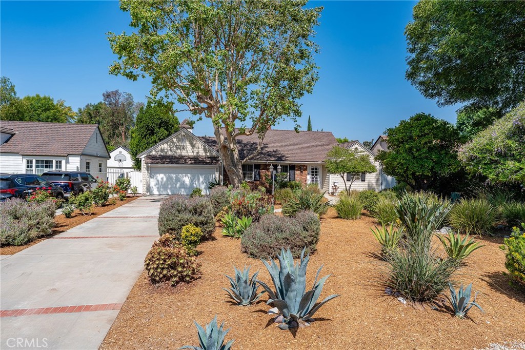 Discover one of the Valley’s hidden gems—a wide, beautiful street with oversized flat lots, impeccably maintained homes set back from the street, mature trees, verdant landscaping and a charming feel. Tucked into the coveted Cameron Woods neighborhood – arguably one of the most beautiful streets in LA - this ranch-style 4-bedroom, 2.5-bath single-story home offers the rare combination of a remodeled interior and an expansive, flat 19,000+ square foot lot. Inside, sunlight pours into every room, highlighting gleaming hardwood floors and a seamless open floor plan. The stunning granite kitchen features stainless steel appliances, including a gas cooktop with hood, double oven, double drawer dishwasher, and French door refrigerator. The large kitchen island provides room for more storage. A picture window over the built-in desk showcases your gorgeous backyard.
The home’s layout is both welcoming and functional, the living and dining areas flow seamlessly to the open kitchen. A double-sided fireplace in the living/dining room and a second gas fireplace in the large den/fourth bedroom create a cozy atmosphere. Marble bathrooms have been updated with style and attention to detail, offering a spa-like experience throughout. Other features include recessed lighting, plantation shutters and Smart home elements such as a programmable thermostat, Ring doorbell and exterior Ring cameras. The attached, two-car garage has been expanded to provide extra storage. Outdoors, stone walkways wind through the luscious back yard. Enjoy the lush, drought-tolerant landscaping, vibrant mature fruit trees, and 10 large raised redwood vegetable/flower beds that make this property feel like a private park. Step out from the kitchen onto the spacious deck—an entertainer’s dream for dining under the stars or weekend lounging. Enjoy your morning coffee in one of the many serene sitting areas, including the vintage brick patio off of the 4th bedroom/den, work or create art in the freestanding office structure or plan your next project with all the extra space – the possibilities are endless Located just minutes from Sherman Oaks, this peaceful enclave blends suburban charm with city conveniences.