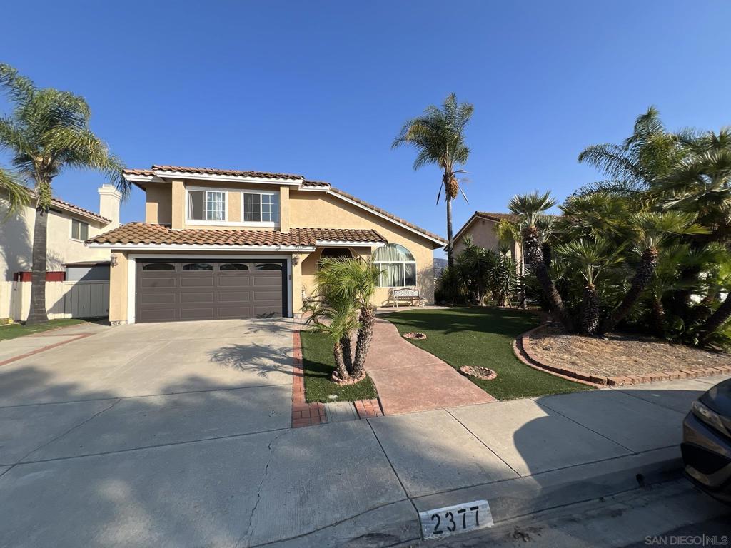 Welcome to this meticulously maintained 3-bedroom, 2.5-bathroom home with a 2-car garage, nestled in the highly sought-after community of Rancho San Diego. As you step inside, you’ll be greeted by a spacious and inviting living room that flows seamlessly into a formal dining area—perfect for entertaining. The upgraded kitchen boasts custom cabinetry, granite countertops, and stainless steel appliances, opening to a generously sized family room with a cozy fireplace. The entire first floor features elegant tile flooring, enhancing both style and durability. Upstairs, enjoy warm wood flooring throughout, including in the expansive primary suite complete with a remodeled en-suite bathroom. All bedrooms feature custom-built closets, providing ample storage. Wake up to stunning, unobstructed views of the mountains and golf course from the primary bedroom—an everyday luxury. The large, flat backyard is ideal for outdoor gatherings, featuring a spacious covered patio and panoramic mountain views. Conveniently located near top-rated schools, shopping, and dining. This home truly has it all—don’t miss your chance to see it in person. It won’t last long!