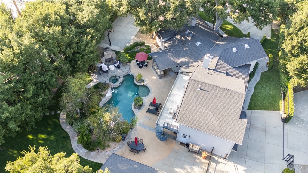 Unmatched Excellence * Nearly $400,000 spent upgrading this Stunning Compound over the last 5 years * One Story with huge Game Room over completely finish 3 Car Garage * Huge Corner lot approaching ¾ of an acre * Additional detached Completed 1 BR Guest unit (ADU), with additional 3 Car Garage and Workshop * Entertainers Dream Yard w/Sparkling Pool/Spa, Waterfall, Huge Stone/Masonry Fireplace, Built-in BBQ with tons of patio space, covered patio, BBall Court, all surrounded by a Park Like Yard of Grass, Trees, Flowers, and Oaks * Inside includes a beautiful Main Suite with Fireplace and Spa Like Bath * 3 additional good sized bedrooms * The Huge Game Room could be an additional 5th BR or In-Law Retreat with its own Private Bath, Wet Bar, 120 Inch Theater Screen, Patio Deck and Stairway down to the yard *Custom Wood Floors throughout * Spacious FR with Massive Custom Wood Burning Fireplace & 77 Inch Theater Screen just off the Designer Kitchen w/Viking Range along with all additional High-End Appliances * Upscale and very roomy Formal Dining * Custom, Window Treatment, Granite, Tile, Doors and Light Fixtures throughout provides character and class at every turn * One of the finest features is being able to enjoy the beautiful pool and yard from the all Newer Windows which also makes the interior very Light and Bright * The Guest House is a fully functional 1+1 approx. 650SF with walk-in closet making it a possible rental or multi-gen use * For the Baseball Fans a fully functional Batting Cage * Besides the 6 Garage Spaces there is tons of parking for RV, Boats and Toys * Newer AC units just replaced * Measured SF - House 3,598+ADU 655 = 4153