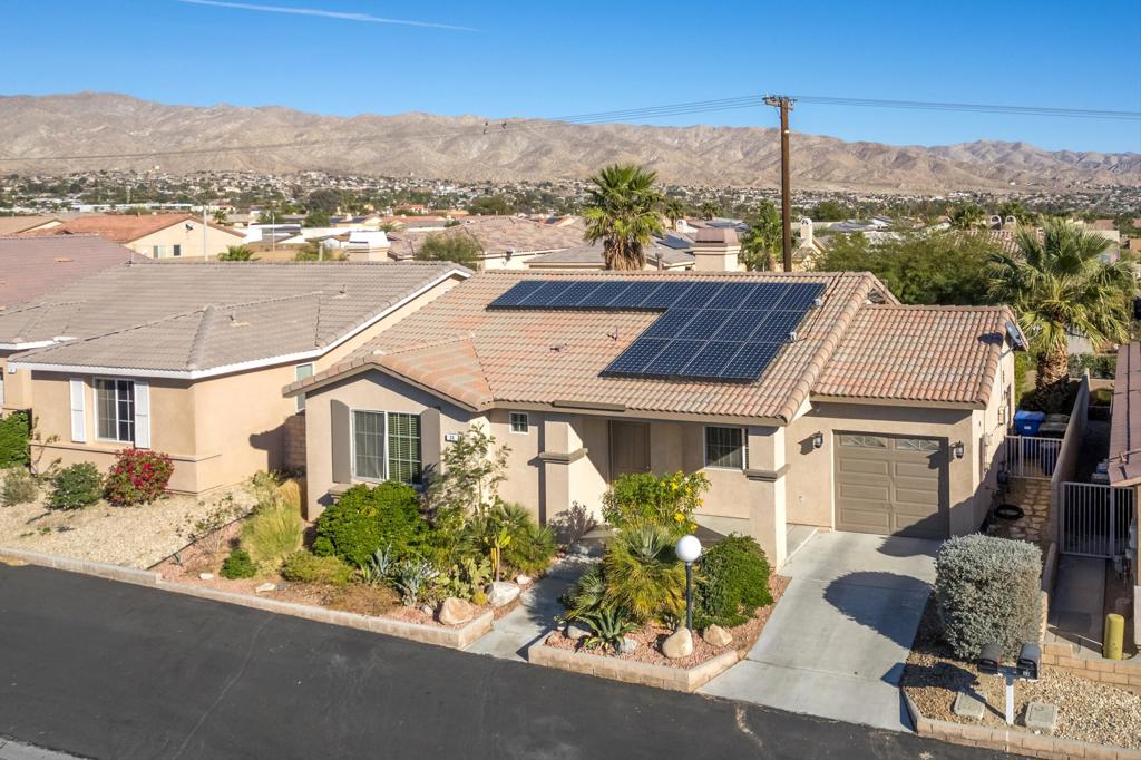 Discover this solar-powered home in the desirable Desert Willows Community, offering an exceptional and affordable 55+ senior lifestyle. The 2004-built home seamlessly blends comfortable indoor living with inviting outdoor spaces.Resort-Style Amenities & Low HOA FeesEnjoy a vibrant, active community with access to a pool, spa, gym, library, card room, billiards, and scenic walking paths. A dynamic social calendar keeps things lively, and all these fantastic amenities come with an incredibly low $265 monthly HOA fee.>Eco-Friendly & EconomicalSay goodbye to high utility bills! This home boasts solar power, with the owner reporting zero electricity costs for the past five years**. Additional energy-efficient features include an electric car charger and an evaporative-cooled, insulated patio cover, making this home as kind to your wallet as it is to the planet.>Spacious & Thoughtfully Designed InteriorsBedrooms: Two generously sized ensuite bedrooms each feature large walk-in closets, providing ample personal space.Bathrooms: Two modern bathrooms offer privacy and convenience.Living Area: The welcoming living room is highlighted by a cozy fireplace, a large picture window, and elegant wood flooring.Kitchen: A spacious, tiled kitchen includes a convenient built-in banquette and sliders leading directly to the backyard, perfect for indoor-outdoor entertaining.> Private Outdoor OasisThe property features beautiful, mature landscaping** that enhances its curb appeal. The private backyard offers a serene space for relaxation or entertaining.>Convenience & StorageLaundry Room:** A dedicated laundry room comes with **full-size appliances** and ample storage cabinets.Garage:The garage provides additional storage space, an electric car charger and direct access to the side yard.---This property truly offers the best of desert living: affordable, convenient, and packed with premium features.