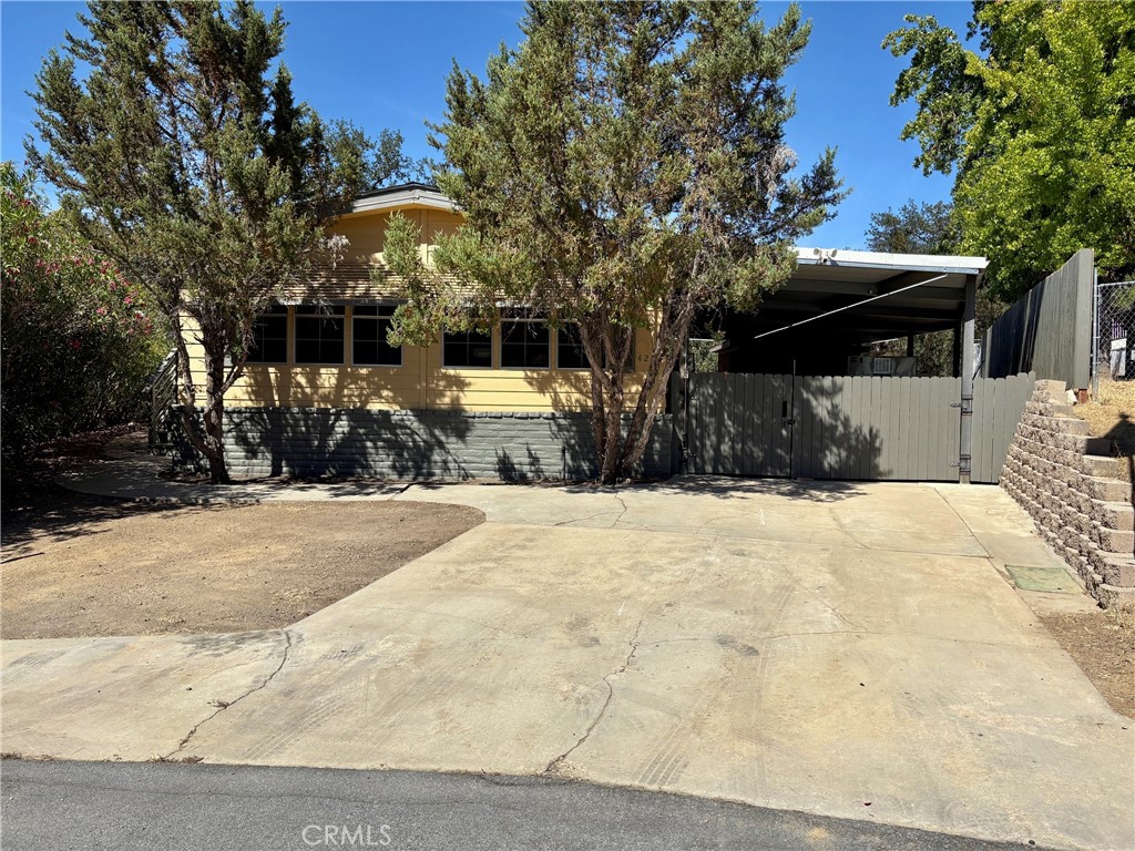 Professional photos coming. Adorable renovated manufactured home at Lake Nacimiento in the gated community of Heritage Ranch. Massive 1300sqft (owner measured) metal carport perfect for all your toys; pontoon boat, trailer, razor, golf cart…. with a 12x16 workshop powered by 110.
Inside the home you’ll find beautiful plank flooring with an open floor plan flooded in natural lighting. Freshly painted, new light fixtures, upgraded bathrooms and custom wood trims. 2 bedrooms plus large bonus room brings the square footage up to approx 1400, per owners. Nestled in a private parklike setting with majestic oaks, canyon views, seasonal creek and beautiful roses. Large decking with a covered bar top and prep station (sink included) perfect for entertaining. Maybe instead enjoy the peacefulness and privacy the deck offers while star gazing to the songs of nature as you backup to open space. Home is nestled at the end of a cul-de-sac far from the main road. Enjoy all this gated community has to offer; private boat launch and marina, pickle ball courts, tennis courts, equestrian center, miles of horse/bike/hiking trails, recreation barn for events and more. This is an all age very active community with events year around such as fishing tournaments, bbq’s, pancake breakfast, poker nights, movie nights and the list goes on. We have a fully staff fire station inside the gates along with our own library. Hop in your golf cart and head to the restaurants just outside the gates along with; grocery store, hair/nail salon, gas station, gym and k-8th grade school. No need to leave we have it all. Just 20 min to downtown Paso Robles and 40 minutes to central coast beaches.The community is nestled in wine tasting country so plenty of things to do. Wake surfing, water skiing , paddle boarding and we even have our own campgrounds with full hook ups.