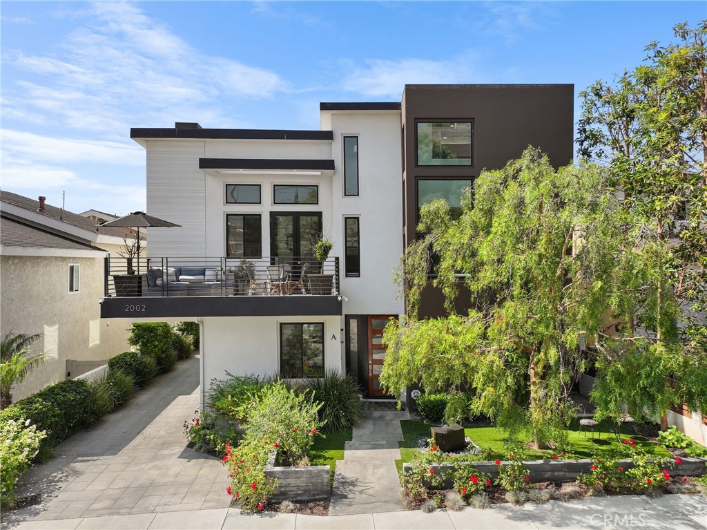 Tucked away on a quiet North Redondo one-way street, this stunning townhome feels like a private retreat. A gated garden path with a zen-like, refillable custom stone fountain leads to your private front entrance, setting the tone for what's inside.
The inviting entry way leads to two en-suite bedrooms, a laundry room, direct-access garage, and a storage closet. The second level impresses with dramatic ceilings, skylights, and open-concept living and dining spaces, anchored by a fireplace that will surely impress your guests. The chef's kitchen is equipped with premium appliances, a prep-sink island, sleek finishes, and self lit pantry. French doors leading to a spacious balcony create the ultimate indoor/outdoor living that everyone will enjoy. The primary suite is a sanctuary featuring a 2nd fireplace, a custom closet, a spa-like bathroom with a jetted tub, and dual vanities with their own sink. A fourth bedroom is currently used as an office, a full guest bathroom, and a dry bar with storage and cabinetry complete this level.
The 3rd floor is a loft and counts as the 5th bedroom with its own bathroom and closet. This room could also be used as a guest suite, office, media room, or workout room. Added comforts include central A/C, alarm system with cameras, central vac, tankless hot water heater, custom window treatments, and more.
With Manhattan and Hermosa Beach just minutes away, along with award-winning schools, parks, shops, dining, and close proximity to LAX and freeways, this is modern coastal living at its finest. A rare turn-key architectural beauty is ready for the next lucky owner!