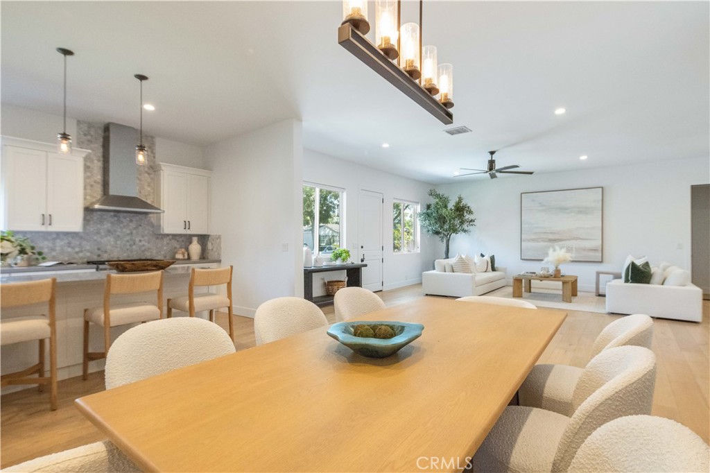 Located on a spacious corner lot in Eastside Costa Mesa, this
exceptionally maintained home was built in 2018 and still feels fresh,
stylish, and thoughtfully designed. The layout offers a true single-level
living experience with all four bedrooms and three bathrooms on the
main floor, complemented by ten-foot ceilings, wide-plank wood
floors, and eight-foot interior doors throughout. The open-concept
kitchen features a tumbled Carrara marble backsplash, walk-in
pantry, KitchenAid Professional Series appliances, built-in wine fridge,
and custom shelving. The primary suite is a true retreat, offering two
oversized walk-in closets and a spa-inspired bathroom with marble
floors, a Victoria and Albert soaking tub, and a full-length LED mirror.
Above the garage, a generous 690 square foot bonus suite with its
own entrance, bathroom, and dedicated air conditioning creates the
perfect space for a guest suite, home office, gym, or creative studio.
Energy-efficient upgrades include a tankless water heater and 220V
outlet in the garage for electric vehicle charging. The oversized two-
car garage features an eight-foot roll-up door and has space to
potentially fit a third vehicle. There is also dedicated parking for RV
or boat parking. The exterior includes low-maintenance turf, mature
fruit trees, a block wall for privacy, and space to add a pool. A covered
front porch with a classic Dutch door offers charming curb appeal,
and a nearly 700 square foot rooftop deck provides an additional
private space for relaxing or entertaining. Ideally located near
Newport Back Bay, the Orange County Fairgrounds, top-rated
schools, and all that Eastside Costa Mesa has to offer.