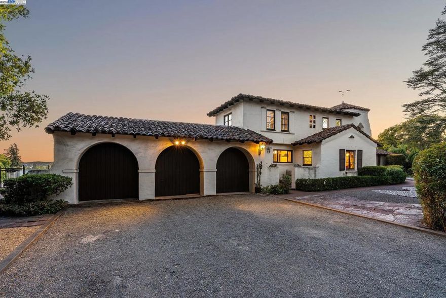 A rare opportunity to own a true Spanish Colonial estate in the heart of Hayward. Set on nearly three-quarters of an acre, this 3-bedroom, 2-bath residence offers approximately 3,488 sq. ft. of living space with timeless architectural character and exceptional privacy. Tucked away at the corner of historic Prospect Street, long regarded as “the Mayor’s Street” for its lineage of Hayward mayors and dignitaries, this estate sits beyond a private road that offers a quiet and secluded escape. The setting evokes a sense of retreat while remaining just minutes from downtown Hayward and major commuter routes. Steeped in local history, the property features the first residential swimming pool ever built in Hayward, set against panoramic views that stretch to downtown San Francisco, including the Salesforce Tower and city skyline. The pool deck and mature landscaping create a serene, resort-like ambiance rarely available at this price point. Properties of this caliber are typically found in Hillsborough or the Oakland Hills—yet here, it remains within reach. The expansive lot offers space for entertaining, gardening, or future expansion, appealing equally to those seeking a signature residence or a distinctive investment opportunity.