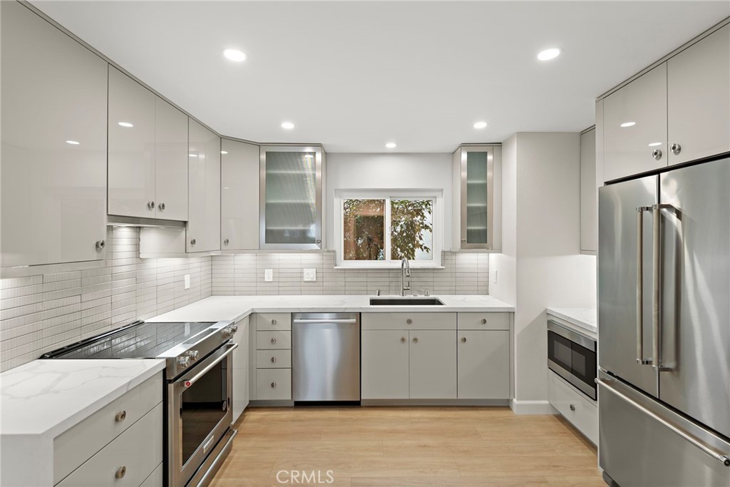 Welcome to this exquisite Villa Puerta model in Laguna Woods, available as a SHORT-TERM, FULLY FURNISHED rental. Recently remodeled from top to bottom, this 2-bedroom, 2-bathroom home also includes a dedicated office space—ideal for remote work or creative projects.
The open-concept design showcases recessed lighting, luxury laminate wood plank flooring, designer paint, and energy-efficient dual-pane windows. Year-round comfort is ensured with mini-split AC/heat, while stylish finishes add warmth and sophistication throughout. The chef’s kitchen boasts KitchenAid appliances, custom cabinetry, and modern designer details. Bathrooms feature under-cabinet lighting on the vanities, with the primary suite offering a spa-inspired walk-in shower highlighted by a backlit niche and contemporary tilework.
Step out to your private balcony and enjoy sweeping hillside views—perfect for savoring morning coffee or unwinding at sunset. Offered fully furnished, this residence combines style, comfort, and convenience within Southern California’s premier 55+ community, complete with golf, pools, fitness centers, clubhouses, and more.
