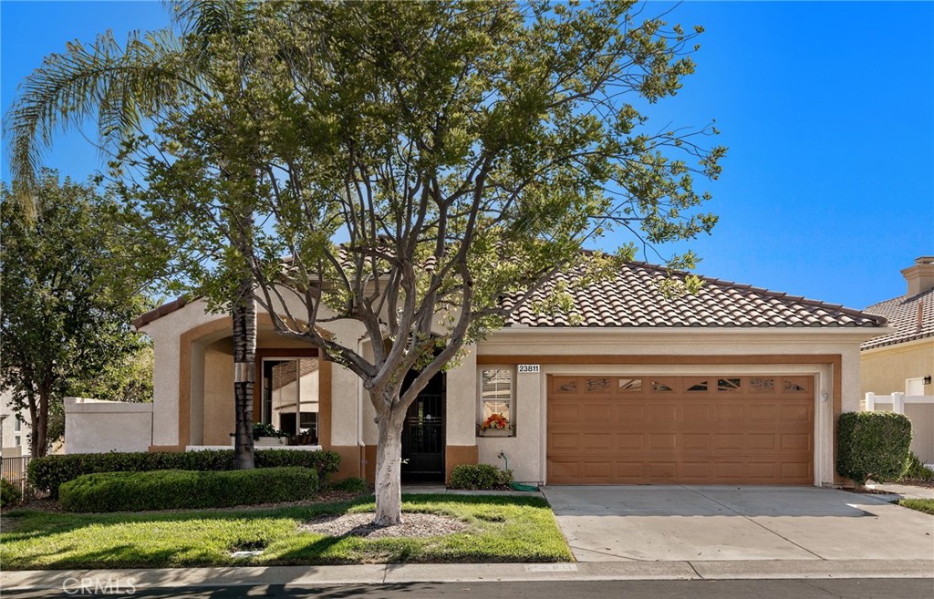LOVE AT FIRST SIGHT - This BEAUTIFUL home has the UPGRADES YOU LOVE on a PREMIUM GREENBELT LOT. NEW LVP flooring in most rooms & wide baseboards are featured in this popular plan offering comfortable daily living with space for entertaining. Home is FRESHLY PAINTED throughout & has vaulted ceilings & lots of natural light. An entry gate welcomes you to a large covered porch with textured concrete finish. The BEVELED GLASS DOOR opens to a spacious living & dining room. The kitchen has elegant upgraded cabinets w/ glass accent doors, solid surface countertops & a double oven. The island can accommodate barstool seating & there is an area for casual dining. The family room features a fireplace & sliding door to the back patio with decorator wood casing accents on the windows & doors. The spacious primary bedroom has a dual sink bath with a soaking tub, a separate shower & a large walk-in closet. There is a guest bedroom & a nearby guest bath with a newly updated cabinet & sink. Bedroom #3 is used as an office/den with a built-in desk (no closet). Your PATIO IS A PRIVATE OASIS with textured concrete, a built-in BBQ, a fountain & PUSH-BUTTON ROLL DOWN SHADES. You will love the quiet location with a large HOA maintained greenbelt behind you & on the side so you only have one neighbor. The indoor laundry with a sink & lots of cabinets adds to the convenience. Your 2-car garage offers lots of built-in cabinets. The home features MOEN water detection system favored by insurance companies. Nestled in The Colony, a vibrant 55+ GATED COMMUNITY, this stunning residence grants access to a RESORT STYLE CLUBHOUSE with an array of amenities for an unparalleled lifestyle. You will love the year-round pool, 2 spas, lighted pickle ball/paddle tennis & tennis courts. You can enjoy the gym, library, ping pong, billiards, hair/nail salon. There are groups & activities for all interests with an auditorium for shows, dances, banquets, concerts, movies, bingo & parties for all occasions. A privately owned 18-hole golf course is inside the gate. The HOA waters & maintains all front landscaping. Guard gated entry and 24-hour security patrol give you peace of mind. In the safe city of Murrieta, you are close to stores, restaurants, medical, casinos and wineries. Enhance your retirement years with the friendly neighbors & sense of community as you enjoy TRUE RESORT STYLE SENIOR LIVING in The Colony.