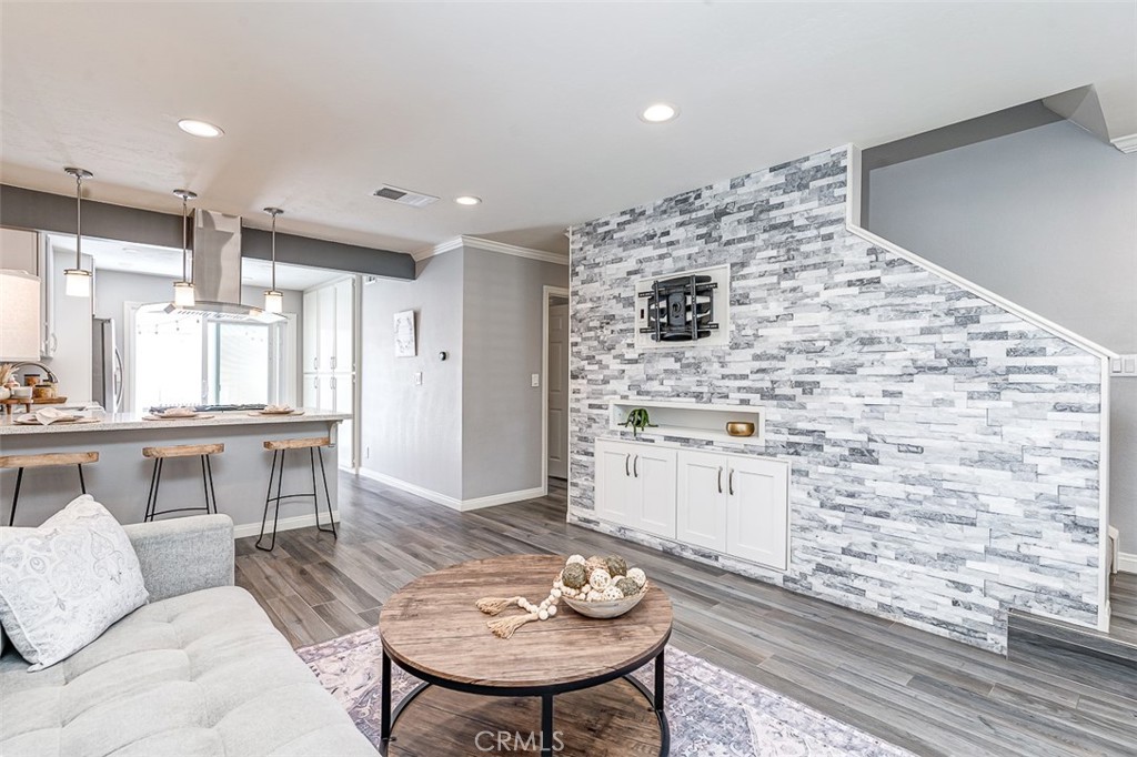 Beautifully Remodeled Condo in the Heart of Lake Forest. Welcome home to this stunning, fully remodeled condo offering modern comfort and versatile living in one of Lake Forest’s most desirable communities. This bright and airy home features an open-concept layout with stylish upgrades throughout — perfect for relaxing and entertaining. The main floor boasts a rare full bedroom with a custom Murphy bed and an adjacent full bathroom, ideal for guests, a home office, or multi-generational living. The remodeled kitchen showcases sleek cabinetry, premium granite countertops throughout, and stainless steel appliances, seamlessly flowing into the inviting living and dining areas. Enjoy serene outdoor living with a private patio, perfect for morning coffee or evening gatherings. Additional highlights include fully finished garage with a Level 2 charger fro your EV, upgraded epoxy flooring, fresh paint, and designer finishes that make this home truly move-in ready. Conveniently located near shopping, dining, top-rated schools, and parks, with easy freeway access — this condo offers the best of Lake Forest living. Don’t miss the chance to make this beautiful home yours!