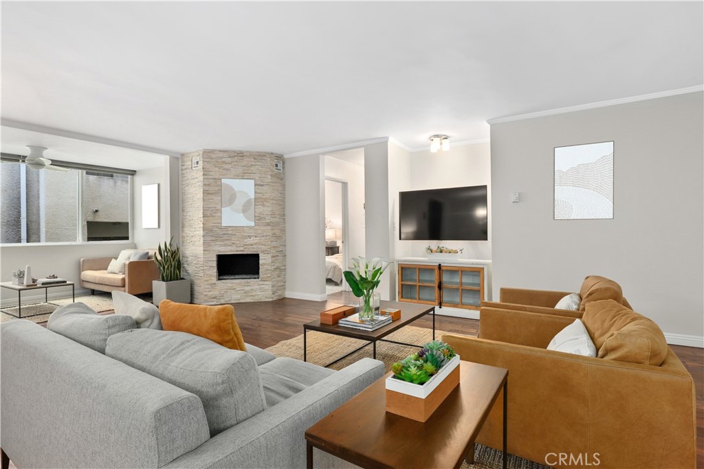 Experience the best of Santa Monica living in this stunning 2-bedroom, 2-bath modern updated SINGLE STORY condo just two blocks from Ocean Avenue which has breathtaking Pacific Ocean views. Spanning 1,369 sq ft on a single level, this open-concept home offers a seamless flow from the spacious living room — featuring rich hardwood floors and a sleek stone-finished fireplace — into the dining area, perfect for entertaining. A versatile den/flex space is bathed in natural light from large windows, offering the perfect spot for a home office or reading nook. The kitchen is beautifully appointed with tile floors, caesarstone countertops, and high-quality stainless steel appliances, including a brand-new dishwasher. The expansive primary suite is a true retreat, complete with a walk-in closet, an additional closet, and a luxurious en-suite bathroom boasting dual sinks and premium finishes. A nice sized guest bedroom and a stylish second bathroom complete the layout. Enjoy the amenities, including an inviting pool, two assigned parking spaces, and an individual storage cabinet. HOA dues cover water, sewer, trash, building maintenance, and insurance (including earthquake insurance). All of this, just moments from Santa Monica Beach, the 3rd Street Promenade, Montana Avenue shops and dining, the famed Santa Monica Stairs, and within an award-winning school district.