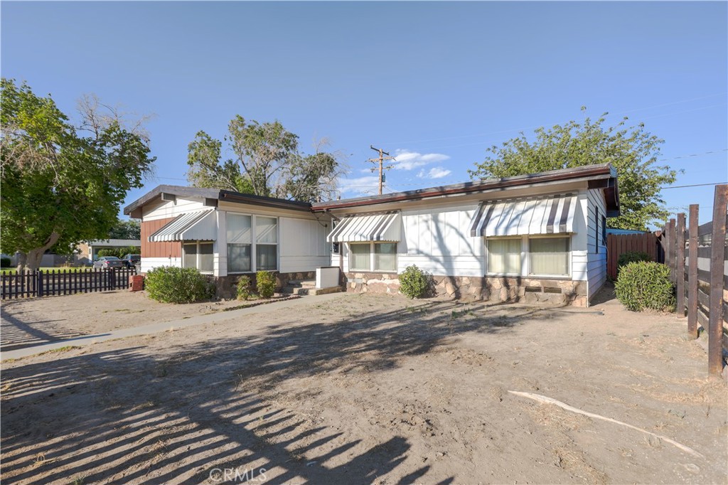 Excellent opportunity, walk into the spacious open beam living room with unique original hardwood floors as you step over to the formal dining room, take a look at the spacious kitchen with plenty of cupboard and counter space with an excellent spacious layout / floorplan, make your way down the hall and take a glance at the four spacious bedrooms with vaulted / open beam ceilings, one full bath accesible at the hallway and the other adjacent to the master bedroom, step outside and enjoy the large custom deck under the large shady tree, covered patio, two car detached garage with garage door opener located on an ideal corner lot - this home is seeking a new homeowner to call it "Home Sweet Home"