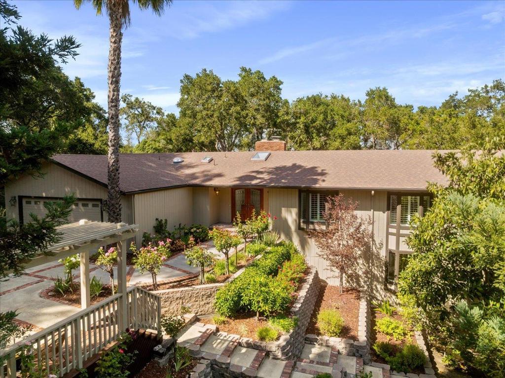 Discover serene & private living in the highly sought-after Vista Del Monte neighborhood in iconic Los Gatos. This 5 bedroom, 4 bath home boasts an inverted floor plan, with the owner's suite, three additional bedrooms, two full bathrooms, living room, dining room, laundry room, and a large, updated kitchen (2014) all conveniently located on the entry level. The huge chef's kitchen is a highlight, featuring top-of-the-line stainless steel appliances, including a Sub-Zero refrigerator & gas stovetop. It also offers a generous island w/ a prep sink and seating, & an eating area that opens to a beautifully designed side yard. On the lower level, a spacious family room w/ a cozy fireplace, an additional bedroom, & a full bathroom offer excellent potential as a secondary living unit. The exterior provides an abundance of outdoor entertaining space with multiple decks, a built-in barbecue, an outdoor fireplace & a play structure for the kids. The natural aesthetic of the pool & hot tub seamlessly blend with the stunning oak-studded natural surroundings. Large unique windows throughout the home invite the beauty of the outdoors inside while a nearby path provides easy access to town & top-rated Los Gatos schools, making this cul-de-sac location the perfect retreat after a busy day.