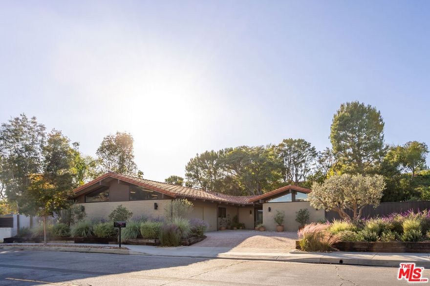 Set in the exclusive Westridge enclave of Mandeville Canyon, this reimagined 5-bedroom, 4-bathroom single-level home offers a rare blend of high design, natural beauty, and city convenience.Inspired by Scandinavian aesthetics, the home features white oak floors, custom oak cabinetry, limewashed walls, and natural textures throughout. At its center, an open-air courtyard with a mature olive tree brings in natural light and a sense of calm.The chef's kitchen pairs La Cornue and Thermador appliances with Dekton countertops, European hardware, and a walk-in pantry balancing function with refined style. Vaulted ceilings and expansive living areas create a seamless, sunlit flow.The primary suite offers a private escape with a spa-like bath, freestanding soaking tub, and dual vanities. Each additional bathroom has been thoughtfully updated with designer finishes. A flexible bonus room (currently used as a gym) and a whole-house water filtration system support wellness-focused living.With direct trail access to sweeping city and coastline views just minutes from Brentwood, the beach, and the Westside this is a rare opportunity to own a private, design-forward retreat in one of L.A.'s most sought-after canyon settings.