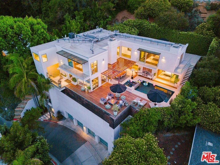 Perched in the serene Hollywood Hills, this stylish lease offers the perfect blend of modern comfort and California charm. Behind a gated entry, the property unfolds into a light-filled open floor plan with expansive windows that frame lush canyon scenery and invite in soft natural light throughout the day. Completely Renovated, Modern Contemporary, 4 bedroom/ 4 bathrooms with an extra large office space. Primary and guest baths with extra large bathtubs, limestone floors, granite counters and high end fixtures. The main living area features beautiful dark walnut hardwood floors, a sleek fireplace, and seamless indoor-outdoor flow ideal for entertaining or unwinding in nature's tranquility. on the 400+ square foot dining area patio with pool and Jacuzzi, built in surround sound throughout the entire house. Outdoor spaces feature multiple terraces and patios perfect for al fresco dining, sunset lounging, or hosting friends under the stars. Elevator access and plenty of parking with a four car garage and an extra guest space. Located in the acclaimed Wonderland School district. This property is very special and one of a kind in Laurel Canyon. Available fully furnished.