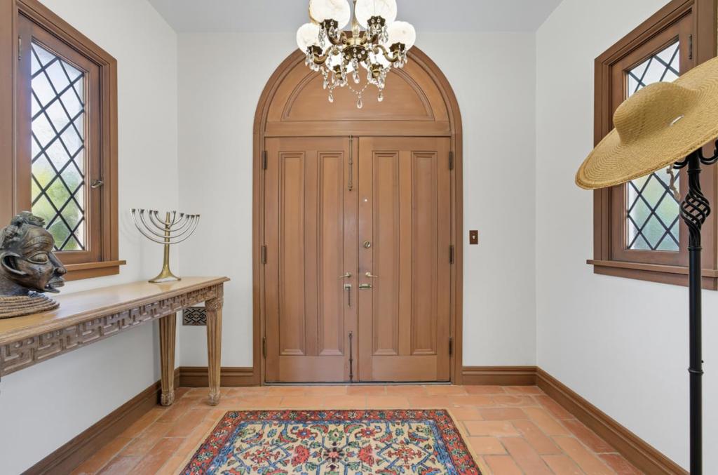 Architectural treasure in the heart of prestigious San Mateo Park! Built in 1924 and influenced by the timeless elegance of Julia Morgan, this single level 4-bedroom, 4-bathroom home offers over 3000sf of refined living space, artfully arranged around a central courtyard that enhances privacy and natural light. Set on a large lot of lush, fragrant grounds, this home is surrounded by fragrant jasmine and vibrant bougainvillea, gardenias, azaleas and abundant greenery. Rich with character and detail, curved double doors, intricate woodwork, brass patina finishes, and leaded glass windows speak to its historic charm and craftsmanship. This home features a large kitchen with stone floors & countertops with state-of-the-art appliances. TWO spacious suites are situated on opposite wings of the home, creating ideal separation for guests, family, or multi-generational living. A grand living room with a stately fireplace and a formal dining room provide gracious spaces for entertaining. French doors invite you outside to the backyard, where a sparkling pool and entertaining patio awaitperfect for gatherings or relaxing in the California sun. This is a lovely blend of classic sophistication, thoughtful design, and timeless charm in one of San Mateos most desirable neighborhoods.