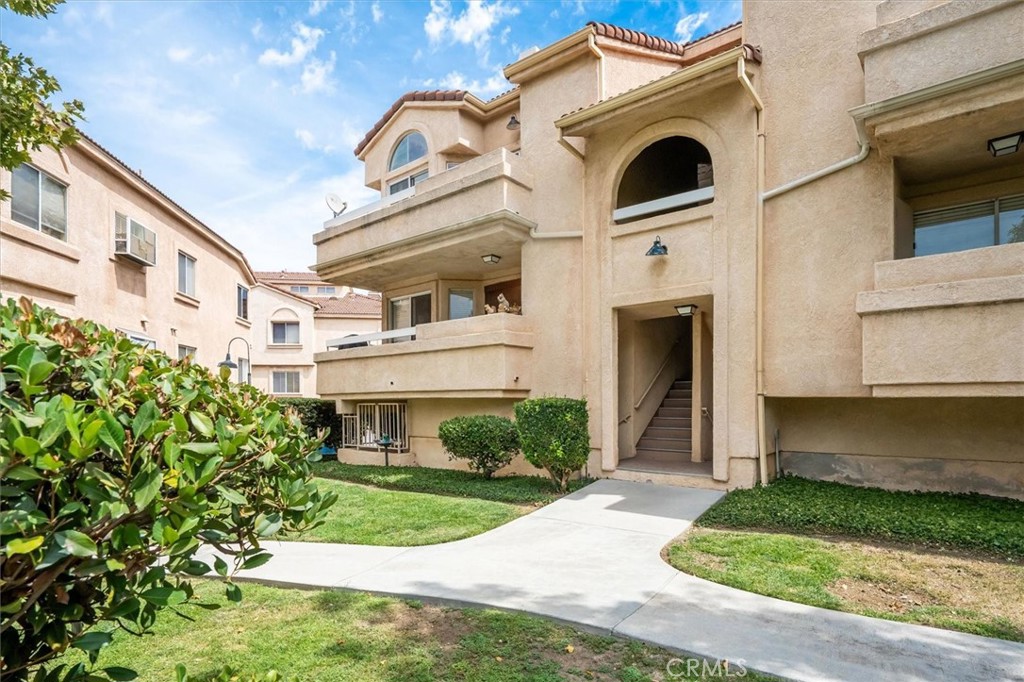 Priced to Sell in Gated Sierra Glen! Welcome to this corner-unit condo offering 3 bedrooms, 2 bathrooms, plus a spacious loft that can be used as an office, gym, or versatile flex space. The living room boasts soaring vaulted ceilings, an abundance of natural light, a cozy gas fireplace, and an open flow into the dining area enhanced by a beautiful chandelier. The kitchen features a newer microwave and stove, updated hardware, and a window over the sink that brings in extra light and a view of the community. Enjoy a private balcony for relaxing or BBQs, convenient indoor laundry with washer and dryer included, and a two-car side-by-side garage—an incredibly rare find in this community! This home has amazing potential with just a little TLC—fresh paint and carpet will make it shine. Additional highlights include high ceilings throughout, an excellent location within the community, and access to a sparkling pool and spa. The Sierra Glen community offers easy access to the 14 freeway, nearby restaurants, and shopping. Don’t miss this opportunity to own a spacious condo in a gated neighborhood at a great price!