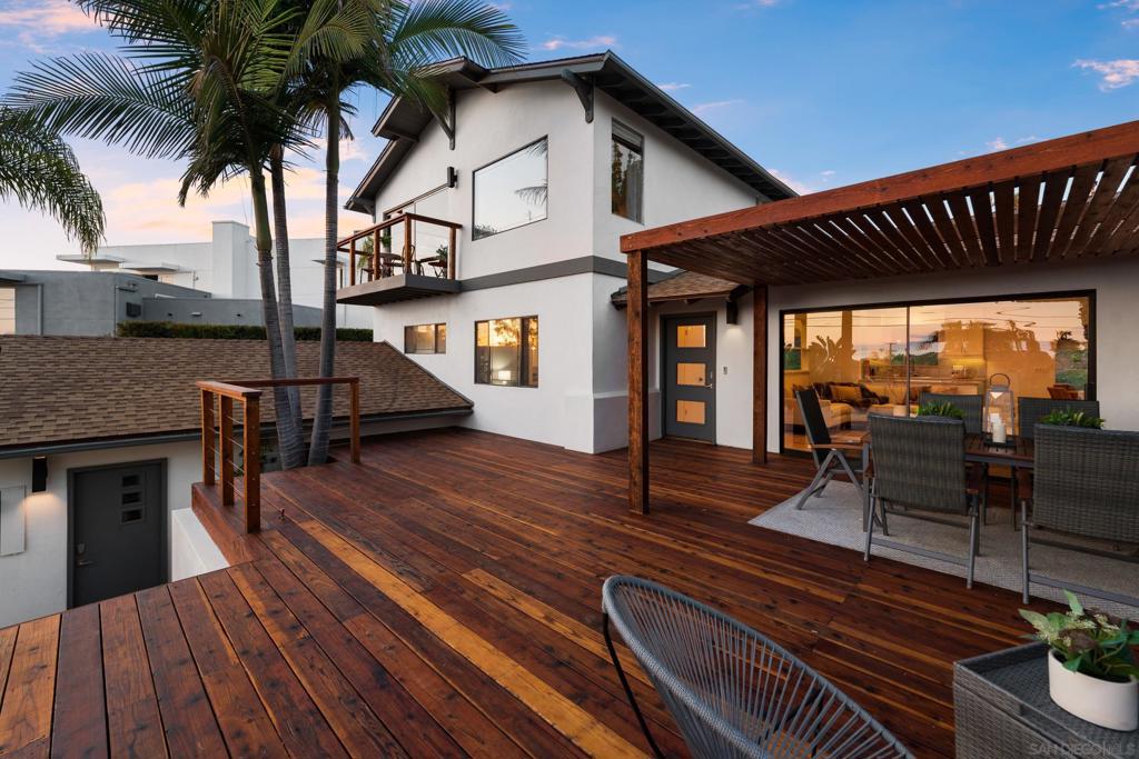 Wake up to sweeping ocean views from nearly every room in this stunning coastal retreat! Perched perfectly to capture the beauty of the Pacific, this 4-bedroom, 4-bath home offers a flexible and inviting floor plan ideal for multi-generational living, entertaining, or simply soaking in the serene surroundings. Enjoy seamless indoor-outdoor living with gorgeous 800 sq. ft ocean-view deck, complete with a stylish pergola perfect for enjoying unforgettable sunsets. Two luxurious primary suites (one on each floor) provide comfort and privacy, each with its own beautifully appointed bathroom and ocean views. The downstairs primary features a spa-like bath with a freestanding soaking tub, while the upstairs suite features oversized shower. The chef’s kitchen was fully remodeled in 2023 and is a true showstopper, featuring shaker cabinetry, Wolf gas range with downdraft, quartzite counters and backsplash, a single-basin sink, and sleek finishes throughout. You will be captivated by double-wide French oak hardwood flooring and even more upgrades including just 2 year old roof, updated front yard sprinkler heads and exterior and stair lighting. This coastal home features midcentury modern style influences through out and is completed with sophisticated updates. Located just minutes away from beaches, shopping, dining, and top schools, this is the perfect blend of style, comfort, and location. Wake up to sweeping ocean views from nearly every room in this stunning coastal retreat! Perched perfectly to capture the beauty of the Pacific, this 4-bedroom, 4-bath home offers a flexible and inviting floor plan ideal for multi-generational living, entertaining, or simply soaking in the serene surroundings. Enjoy seamless indoor-outdoor living with gorgeous 800 sq. ft ocean-view deck, complete with a stylish pergola perfect for enjoying unforgettable sunsets. Two luxurious primary suites (one on each floor) provide comfort and privacy, each with its own beautifully appointed bathroom and ocean views. The downstairs primary features a spa-like bath with a freestanding soaking tub, while the upstairs suite features oversized shower. The chef’s kitchen was fully remodeled in 2023 and is a true showstopper, featuring shaker cabinetry, Wolf gas range with downdraft, quartzite counters and backsplash, a single-basin sink, and sleek finishes throughout. You will be captivated by double-wide French oak hardwood flooring and even more upgrades including just 2 year old roof, updated front yard sprinkler heads and exterior and stair lighting. This coastal home features midcentury modern style influences through out and is completed with sophisticated updates. Located just minutes away from beaches, shopping, dining, and top schools, this is the perfect blend of style, comfort, and location.