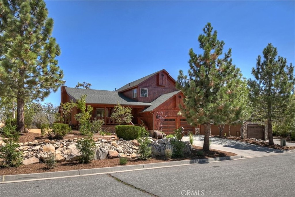 Experience the ultimate Big Bear lifestyle in this updated Castle Glen estates home backing to eagle preserve ~ Designed for comfort and style, this property offers a rare blend of privacy, luxury and mountain charm. Step into the open-concept great room featuring tongue-and-groove pine ceilings, a stunning rock fireplace, and plenty of space to gather. The kitchen is ideal for entertaining, with stainless steel appliances (updated in 2017), granite countertops, knotty pine cabinets, and center island. This spacious home includes four bedrooms with two en suite layouts providing ample space to sleep a crowd. Upstairs, the primary suite boasts a spa-inspired bathroom and private balcony to enjoy the crisp mountain mornings. This home is equipped with air conditioning as well as central heat (upgraded in 2024) to ensure comfort throughout the seasons. Other upgrades include new flooring (2018), new water filtration system (2024), new exterior paint (2024), and professional landscaping (2025). You're going to love the expansive back deck, perfect for barbecues and gatherings, plus a cozy fire pit for relaxing in the evenings. The oversized two-car garage adds functionality and storage. Just minutes from skiing, Big Bear Lake, hiking trails, golf, and The Village, this property is perfect as a full-time home, or vacation retreat and is located in a short term rental friendly neighborhood.