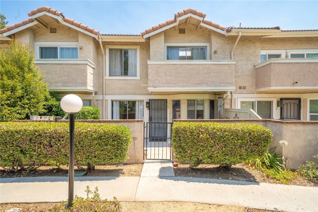 Welcome to 1507 Elkwood Street, your charming retreat in a prime location. This lovely 2-bedroom, 2-bathroom condo has 1,008 square feet of thoughtfully designed living space, perfect for those seeking a cozy and efficient home. The area feels woodsy with many trees and views of the valley! Step inside to find an inviting atmosphere where two large windows allow natural light to highlight the recently remodeled interior. The new wood-look floors in the living area add a touch of elegance, while the contemporary carpet on the stairs and in the bedrooms offer warmth and comfort. The fireplace in the living area is inviting and creates a wonderful ambiance, making it a great spot for gatherings or quiet nights in. There is a bathroom conveniently located downstairs near the entrance to your attached 2-car garage. The upstairs features vaulted ceilings in the bedrooms, providing a sense of openness and light. The primary suite, freshly painted, includes an attached bathroom and dual closets with mirrored sliding doors. Enjoy the outdoors on your two patios – one at the front where you have views of the valley, and incredible city lights in the evening. The large patio/deck off the upstairs landing is a great place to entertain or enjoy morning coffee. Have a relaxing afternoon or evening at the refreshing communal pool and heated bubbling jacuzzi just steps away; perfect for these warm summer days and nights! You will love the proximity to local amenities, all while being just 20 minutes from downtown Los Angeles and 45 minutes to the beach. Air conditioner new in 2023, Water heater new in 2019. You can hike around this beautiful scenic complex for an enjoyable walk or take a short jaunt up the street to the corner for the gorgeous Galster Wilderness Park. This is California living at its finest, and can be best appreciated by seeing it for yourself! This community rarely has a property for sale. HOA covers water, trash, insurance and external maintenance and repairs. Schedule a showing today before FOMO sets in!
