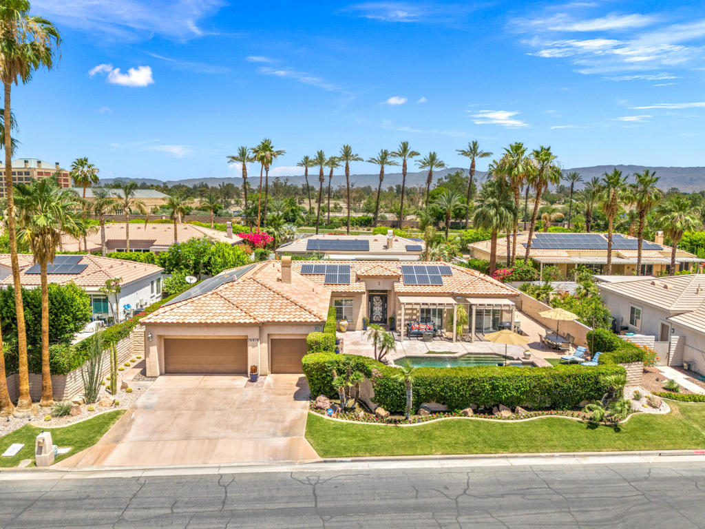 Panoramic mountain views from the home's spacious south facing Courtyard with pool/spa, large green lawn, and extraordinarily large patio for lounging and entertainment. Indoor/Outdoor living at its best, this beautiful, furnished 2544 Sq. Ft., 4 bedrooms, 2.5 baths, 3 car garage home with paid Solar is within the Colony at prestigious Indian Wells Country Club. Beautiful wrought iron gated entry into private Courtyard where pebble tech pool/spa, beautiful palm trees, lawn and south mountain views await you. Front entrance into open Living Room with travertine chiseled stone floors, plantation shutters, high 10' ceilings and beautiful Crown molding throughout. The Fornal Dining area has awesome views, and the Open Kitchen has white cabinets, granite counters, stainless Kitchen Aid appliances including a double oven, bar seating, and a big pantry. The Family Room has a granite fireplace. Primary Bedroom has wonderful views with direct access to pool/spa. Primary Bath has a jet tub, large shower, dual sinks, and big walk-in closet with custom cabinetry. One Guest Bedroom is used as home office and overlooks the pool/spa. Another Guest Bedroom has ensuite Bath with granite countertops, and a large shower. Powder Bath is spacious with pedestal sink. The Laundry Room has a deep tub sink and lots of storage cabinets. Large back lawn with citrus trees and patio which wraps around on the east side of the house. Truly a gem in Indian Wells!
