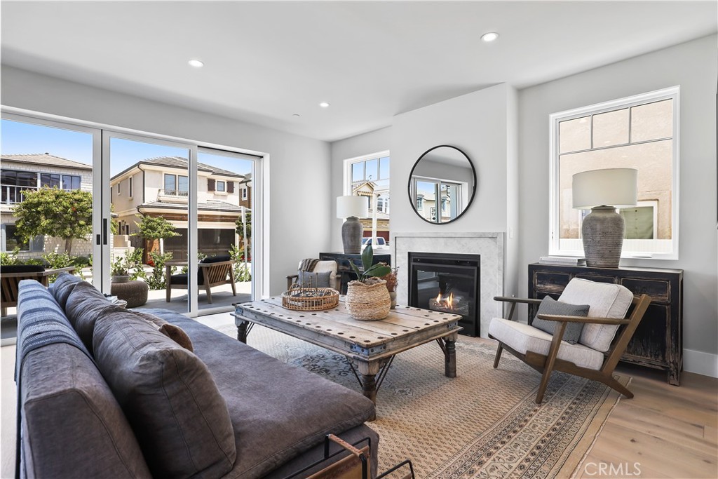 Welcome to your dream coastal retreat at 825 W Bay Avenue Unit A. This stunning new construction condo offers a perfect blend of luxury and comfort, spanning 1,732 square feet of meticulously designed living space. With 3 spacious bedrooms and 4 elegant bathrooms, this home provides an ideal setting for relaxation and entertainment with views of the Newport Harbor from every floor.
Step inside to discover the seamless flow of hardwood floors underfoot, enhanced by the warm glow of chandeliers and recessed lighting. The open kitchen is a chef’s delight, featuring a modern island, Thermador appliances, and a custom range hood. Enjoy meals in the dining room or at the island, creating a versatile space for casual dining or entertaining.
The living area is anchored by a Taj Mahal Quartzite fireplace, providing a cozy ambiance for gatherings. Retreat to the primary ensuite, complete with a double sink bathroom and a walk-in closet. Outdoor living is redefined with a stunning private roof deck with panoramic bay views. A convenient third story powder room also makes it easy to host those summer barbecues with a view.
Embrace the Newport Beach lifestyle in this exquisite condo, where every detail caters to your comfort and style. Located next to a premiere bay beach perfect for soaking in the OC sun, 825 W Bay Unit A is ready to welcome you home.