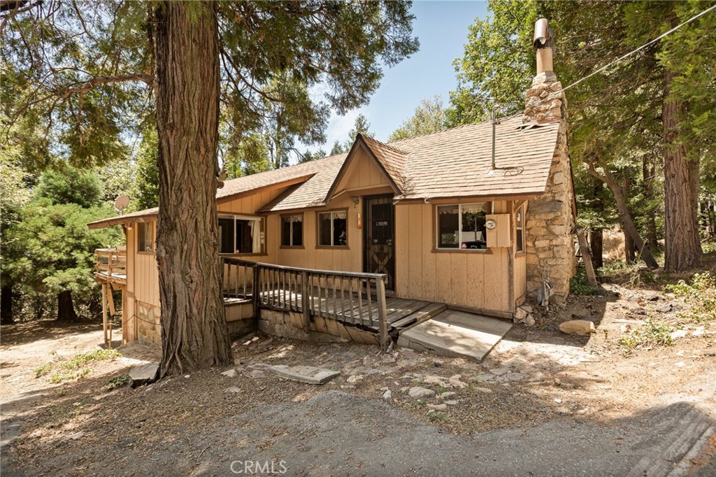 Welcome to 1230 Bear Springs Road, a sweet and cozy single story cabin tucked in the trees of Rim Forest on a large lot. This 2-bedroom, 2-bath home has that unmistakable “grandma’s house” feel—charming, well-loved, and full of warmth. The living area is inviting and simple, with a nostalgic vibe that makes you want to slow down and stay a while. The big, beautiful original fireplace in the living room is where the grandkids used to sit and enjoy the mountain feeling. The layout is practical, and there's great potential to update or enjoy just the way it is. Located close to Highway 18 for an easy commute to the mountain or down the hill, this property is being sold as-is and is ideal for someone looking for a mountain getaway, full-time residence, or fixer upper. A classic mountain gem ready for its next chapter. Some repairs needed. Bring your toolbelt.