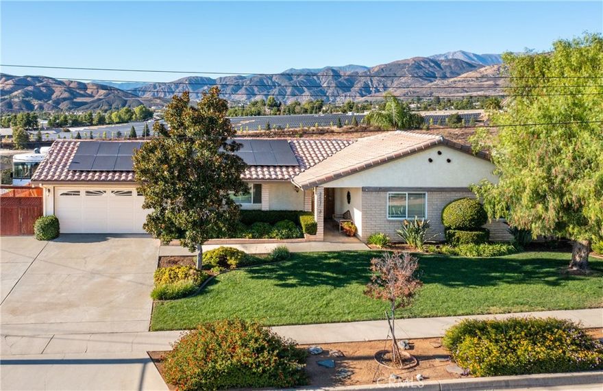 Pictures simply don’t do this home justice with its unbelievable, unobstructed mountain views! Paid for solar! This home has been lovingly cared for by the same owners for over 30 years, showcasing true pride of ownership around every corner. This beautifully maintained 3 bedroom, 2¼ bath home located in a quiet, well established neighborhood. 
Inside, you’ll find upgrades throughout, the front living room has custom built-in cabinets with a remote operated gas fireplace.  There are also boxed wood shutters, Pella windows and doors, and Cat 5/6 internet wiring extending throughout the home for modern convenience. The master suit has clean and comfortable carpet with a mirrored three paneled sliding door and mountain views through a custom sliding glass door with access to the pool. The master bathroom has been remodeled with a walk in shower and custom tile work. It has a large vanity with double sinks and a granite counter top.
Step outside to your own private retreat featuring a newly Pebble Tech salt water pool , built-in outdoor kitchen, and BBQ area that’s perfect for entertaining and soaking in the views. The paid-for solar and new roof offer long-term savings and peace of mind.
The spacious side yard features a shed, mature fruit trees and room for a garden or swing set.
Don’t miss the chance to own this rare view property where comfort, care, and breathtaking scenery come together.