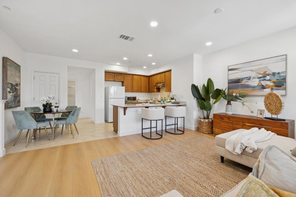 Welcome to 1378 Shore Drive, a beautifully updated 2-bedroom, 2-bath home offering 1,171 sq. ft. of stylish living in a prime San Jose location. This light-filled residence features high ceilings with recessed lighting, new waterproof laminate flooring, six-panel doors throughout, and fresh interior paint. The spacious living and dining area includes a private balcony and a versatile office alcove. The well-appointed kitchen boasts maple cabinets, a breakfast bar, pantry, Whirlpool gas cooktop and oven, stainless steel exhaust fan, Frigidaire refrigerator, Whirlpool dishwasher, and an oversized stainless-steel sink. The primary suite offers a walk-in closet, dual sink vanity, maple cabinetry, a walk-in shower with glass enclosure, and a separate enclosed toilet area. The second bedroom is served by a full hall bath with a shower-over-tub. Additional highlights include a laundry room with side-by-side Whirlpool washer and dryer, an attached 2-car garage with a Level 2 High Speed EV outlet, and HOA coverage for roof, exterior paint, landscaping, and management for just $220/month. Enjoy close proximity to Berryessa BART, VTA, parks, trails, downtown San Jose, and easy access to Highways 280 and 17