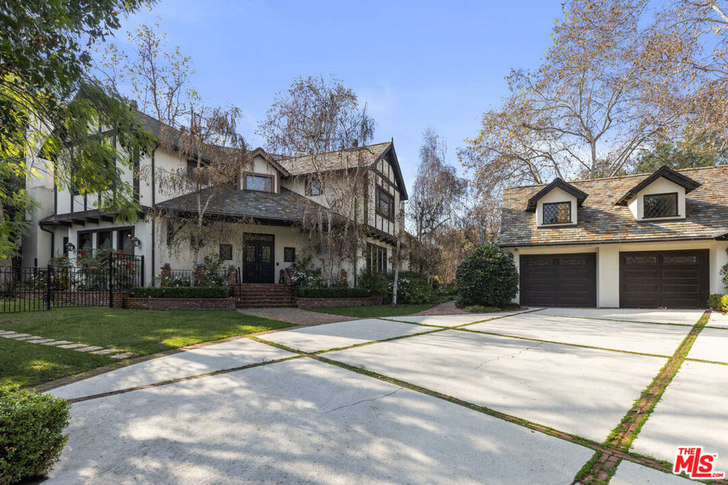 Fully furnished - move in ready! Nested in an exclusive cul-de-sac community and privately gated, 11247 Briarcliff Lane boasts a four-bedroom main residence, separate guest house with ample office space, long driveway and sprawling backyard with direct access to hiking trails. Enjoy the tranquility and beauty of Laurel Canyon and convenient proximity to some of the city's best schools. Enter to find a grand staircase and rich hardwood floors. Continue through the formal dining room to an inviting kitchen with a fireplace and spacious pantry. Stunning chandeliers grace almost every room, including the library and bar. An entertainer's paradise, the home features a smart sound system, theater and backyard oasis with a saltwater pool, pickleball court, fruit trees and waterfall. The upstairs primary suite offers verdant garden views, a spa-inspired bathroom, fireplace and dual walk-in closets. Other highlights include a full security system with cameras, three covered parking spaces and additional driveway parking.