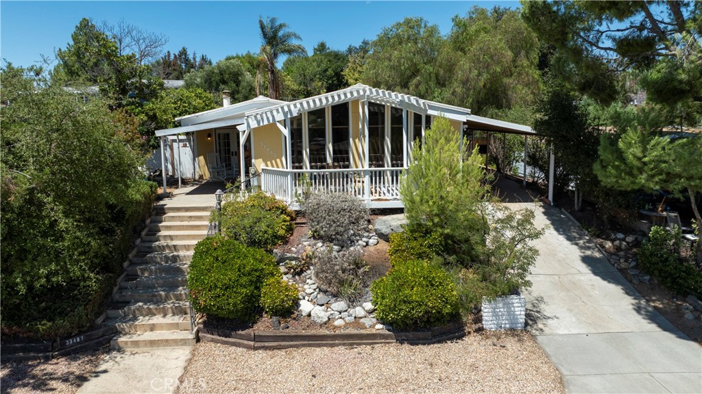 Welcome to 33487 Harvest Way, a charming home located in the heart of the sought-after THE FARM community in Wildomar. This inviting residence is situated on a generous 8,276 square foot lot, and uniquely, this manufactured home is permanently affixed to your own land. With easy access to both the 15 and 215 freeways, this home offers seamless commuting options while providing an escape into a family-friendly community filled with abundant amenities. Spanning 1,800 square feet, this home features 2 comfortable bedrooms and 2 well-appointed bathrooms. The spacious living room, accentuated by a cozy fireplace, provides a warm setting for family gatherings and relaxation. An expansive entryway doubles as a den or office, ideal for those working from home or in need of a versatile utility room. The convenience of an inside laundry room further enhances the everyday functionality of this home. The exterior is equally impressive, offering two sheds for additional storage, there is plenty of room to create your own backyard oasis. The property boasts a covered carport that accommodates 2 or more cars, ensuring ample parking space for residents and guests alike. The elevated property offers a lovely view of the rolling hills, adding a tranquil touch to your living experience.
THE FARM community is brimming with amenities, including three pools and spas, a clubhouse, basketball and tennis courts, a dog park, and community gardens. For nature enthusiasts, scenic hiking trails and fishing ponds are just a stroll away. Moreover, RV storage is available for those with a taste for adventure. This vibrant community is designed to foster an active and engaging lifestyle for all its residents.
With its scenic views and prime location, this home is an ideal canvas for your special upgrades and personal touches. Embrace the opportunity to make it truly your own in this dynamic and welcoming neighborhood.