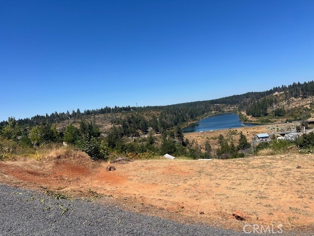 This lot has the most amazing view of the Magalia Reservoir. It's cleared and leveled, just waiting for a beautiful home to be built. The utilities are currently being trenched to the property, the water meter has been installed, there is some fencing at the front of the property, and the septic system is intact along with an inspection report. This beautiful property is worth the short drive, so come check it out!!!