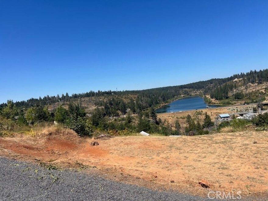 This lot has the most amazing view of the Magalia Reservoir. It's cleared and leveled, just waiting for a beautiful home to be built. The utilities are currently being trenched to the property, the water meter has been installed, there is some fencing at the front of the property, and the septic system is intact along with an inspection report. This beautiful property is worth the short drive, so come check it out!!!