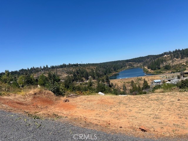 This lot has the most amazing view of the Magalia Reservoir. It's cleared and leveled, just waiting for a beautiful home to be built. The utilities are currently being trenched to the property, the water meter has been installed, there is some fencing at the front of the property, and the septic system is intact along with an inspection report. This beautiful property is worth the short drive, so come check it out!!!