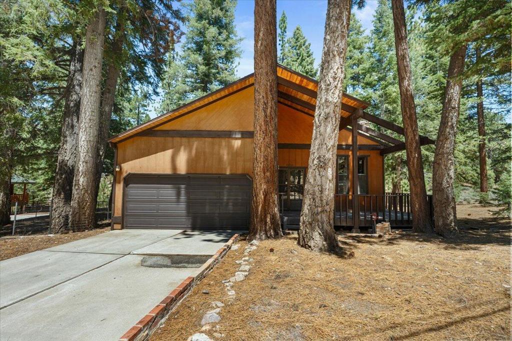Discover this custom-built mountain home in a prime Moonridge location, just minutes from ski slopes, the golf course, and forest trails. Set on a large, level, tree-studded lot backing to Sand Canyon, the property enjoys open forested space behind and beside the home for added privacy and a true mountain feel. The architecturally appealing design features multiple living spaces and stunning vaulted, beamed ceilings that bring warmth and character to the interior. Myriad windows bring the outside in and allow for abundant natural light. The open-concept kitchen offers an island with a gas range, breakfast bar, and an adjacent dining area, perfect for gatherings after a day on the mountain. Two bedrooms plus a large loft provide flexible sleeping arrangements, while the spacious primary suite offers a comfortable retreat. The attached two-car garage and concrete driveway provide convenience, with easy, all-season access for year-round enjoyment. Whether you're looking for a full-time residence, vacation escape, or investment property, this Moonridge gem blends location, design, and natural beauty into the ideal mountain home.