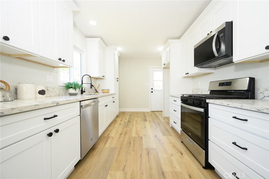 Stunning UPDATED 3 bedroom, 2-bathroom home in Pomona near lively downtown Pomona, shopping and close to freeways 71 and 10 for quick access. The kitchen features shaker-style cabinets with new quartz countertops, and stainless-steel appliances. The home has luxury flooring throughout the living areas and bedrooms, both bathrooms have new vanities, and custom tile work, freshly painted interior and exterior, split air and heat system for your everyday comfort, energy efficient windows, stylish lighting and plumbing fixtures throughout, and indoor laundry. There is ample parking and detached two car garage and spacious yard offers possible ADU potential. Buyer to verify all building codes and ADU guidelines with the city. Tax rolls show different bathroom count.