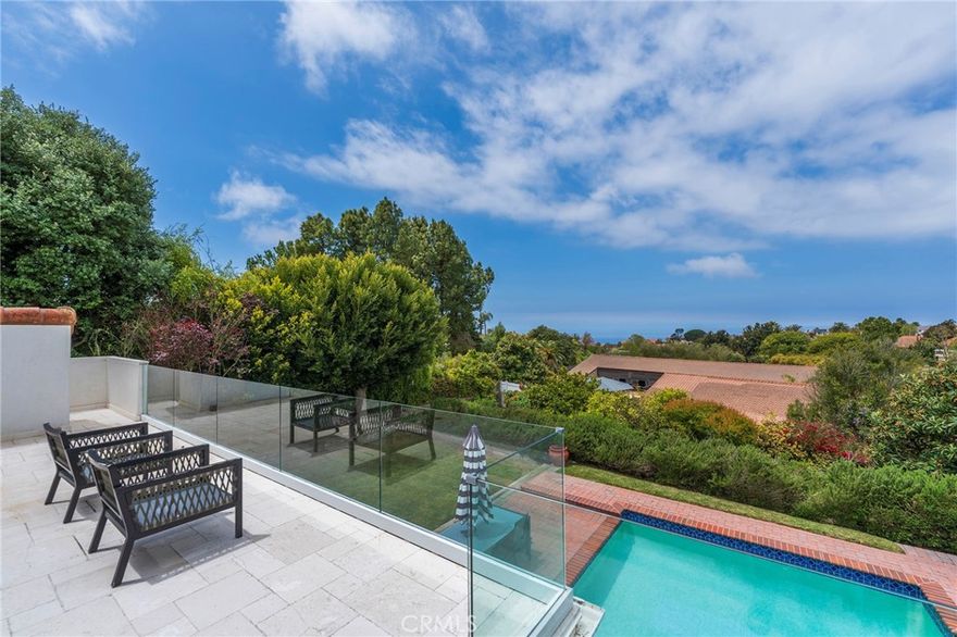 Located within the prestigious guard-gated community of The Ranch, this expansive property offers space, privacy, and spectacular ocean views.
Step through the grand double doors into a soaring two-story foyer, highlighted by a dramatic staircase that sets the tone for this elegant five-bedroom, three-bathroom residence. Situated on an impressive 18,789-square-foot lot, the home combines traditional charm with comfortable living.
The formal living room features a fireplace and flows seamlessly into the adjacent dining room—ideal for entertaining. The spacious kitchen is equipped with a Sub-Zero refrigerator and opens to a warm and inviting family room with a second fireplace, creating the perfect gathering space.
An enclosed covered patio extends the living area and leads to a large backyard oasis complete with two grassy play areas, a sparkling pool and spa, and plenty of space to unwind or entertain. On the main level, you’ll also find a guest bedroom and home office, a full bath, and a laundry room with direct access to the three-car garage. Upstairs, the generous master suite offers a true retreat—featuring a cozy fireplace, dual walk-in closets, a private sunroom, and an outdoor deck with ocean views. Three additional bedrooms complete the upper level. As a bonus, steps down from the backyard reveal your own private orchard, filled with a variety of fruit trees—bringing a touch of nature and tranquility to this already extraordinary home.