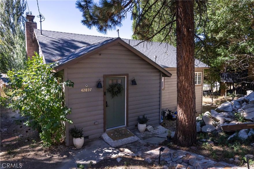 42897 Encino is a charming, vintage-inspired home located within walking distance to the Moonridge Zoo, Bear Mountain's shuttle and parking lot, as well as some of Big Bear's favorite local restaurants and coffee shops. The Moonridge area has been upgraded with new sidewalks and street lights, enhancing the neighborhood's charm and safety for evening strolls. This inviting retreat features an open-concept floor plan with 2 spacious bedrooms and a full bath, situated on a generous 5,369 sq ft lot. Inside, you're welcomed by a bright and cheerful atmosphere, highlighted by a stylish subway tile backsplash in the kitchen and sleek tile flooring for easy cleaning. Savor stunning ski slope views of Bear Mountain and Snow Summit, and begin enjoying them while relaxing with a warm cup of tea by the fireplace, stargazing under a clear mountain sky, or sharing a warm meal with loved ones as the sun sets after a long week. If you're searching for the perfect place to call home, your search ends here!
