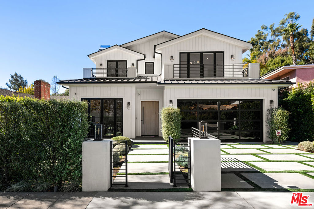 A newly constructed contemporary farmhouse in prime Brentwood, situated on one of the largest flat lots on the street. Featuring a two-story open floor plan that boasts an abundance of natural light, soothing colors, and designer finishes throughout. The main level features the living room with fireplace, dining room, family room, theatre, office, bar, powder room, guest bedroom, and a gourmet kitchen with butler's pantry and breakfast nook. Upstairs, you will find four en suite bedrooms, including the expansive primary suite with a fireplace, spacious bathroom, closet and balcony. Enjoy a seamless indoor-outdoor experience complimented by a peaceful landscape with plenty of space for entertaining. The exterior is complete with a pool, spa, outdoor kitchen, grassy yard, cabana, al fresco dining and terraces for lounging and relaxing.