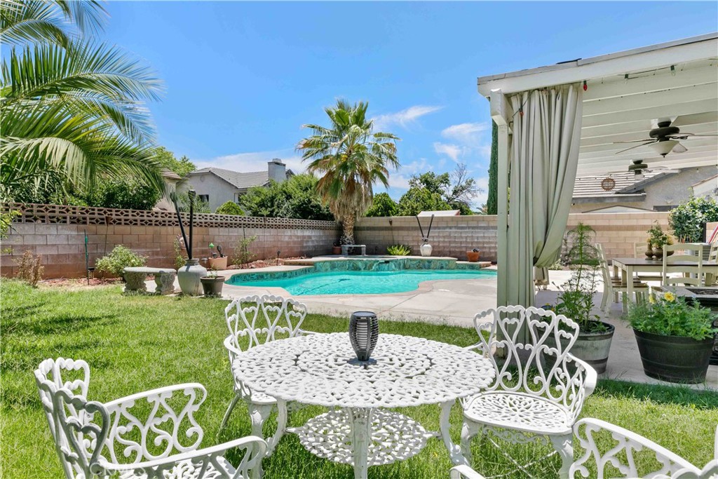 Charming West Lancaster Pool Home! Welcome to the standout home on a quiet West Lancaster street. With a tiled roof, well-kept exterior, and welcoming front porch, this property blends charm and comfort from the start. Inside, a sunlit foyer opens to vaulted ceilings, recessed lighting, plantation shutters, and a striking wood-and-metal staircase. The living room centers around a beautiful stone fireplace, creating a cozy space to unwind. A second fireplace in the adjacent family room adds even more warmth, making it the perfect spot for everyday gatherings. The formal dining room is ideal for entertaining, and the bright kitchen features a breakfast bar with views of the sparkling pool, making mornings extra enjoyable. The lower level offers three spacious bedrooms and two full baths—ideal for family or guests. Upstairs, the private master retreat includes vaulted ceilings, natural light, a large walk-in closet, and a serene en-suite bath. A bonus loft adds versatility as an office or creative space. Step outside to a true entertainer’s backyard with a pool, spa, fire pit, covered patio, multiple seating areas, and an outdoor TV setup—perfect for relaxing or hosting. The home also includes a spacious 3-car garage, offering ample room for parking and extra storage. Centrally located near the 14 freeway, shopping, and entertainment, this home offers the perfect mix of style, function, and location.