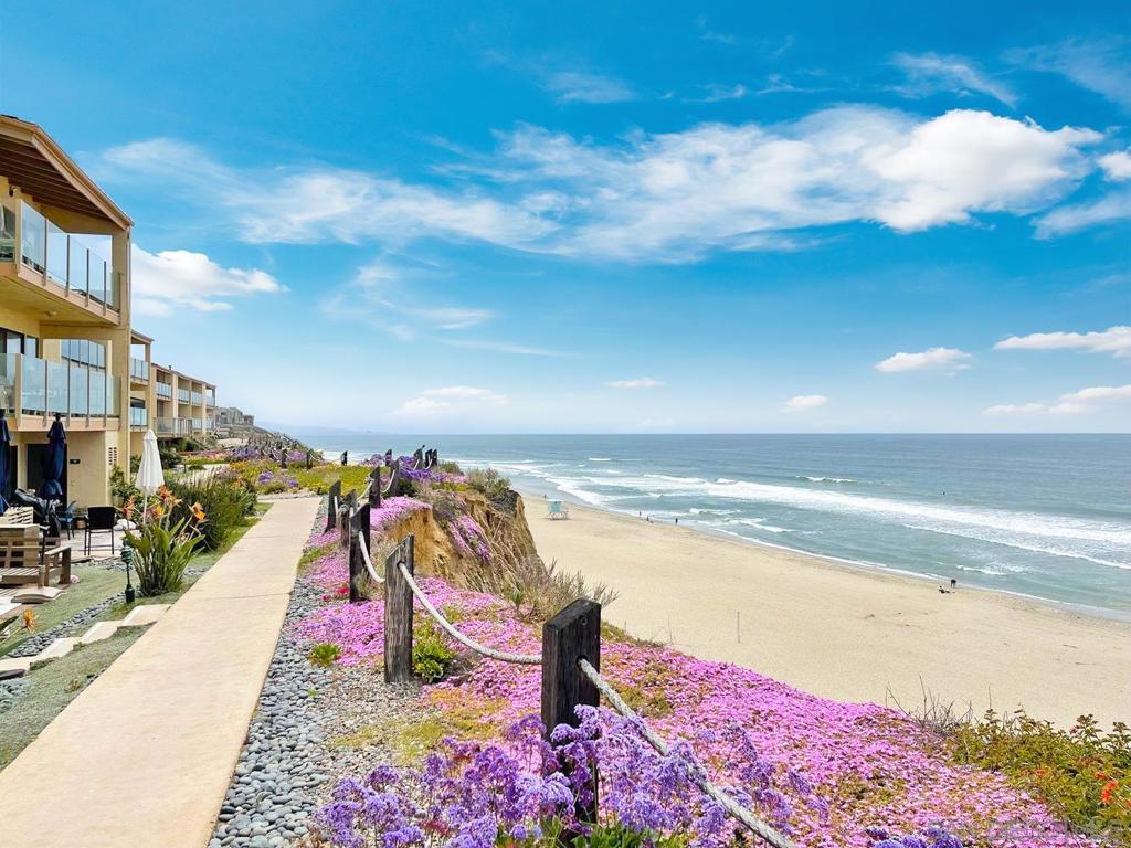Live steps from the sand in this beautifully updated property, perfectly situated in the heart of Solana Beach—one of the nation’s most sought-after seaside communities. Just a short stroll to the ocean, this versatile home offers the ideal blend of a tranquil vacation retreat, an inviting primary residence, or a lucrative rental opportunity with both short- and long-term potential. Inside, you’ll find a thoughtfully renovated interior featuring stylish new cabinets and flooring throughout. The warm, welcoming living room with its cozy fireplace sets the stage for relaxed evenings or entertaining friends. With the added benefit of two parking spaces, convenience meets comfort at every turn. Location, location, location—walk to popular restaurants, unique shops, and the nearby Coaster/Amtrak station for effortless coastal commuting. The gated community further elevates the lifestyle with resort-style amenities, including multiple pools and jacuzzis, tennis courts, a recreation room, and calming koi ponds surrounded by lush landscaping. For added ease, this property is available furnished, providing a true turnkey opportunity—whether you’re ready to move right in or start generating rental income immediately. Don’t miss your chance to own a piece of paradise in one of California’s most coveted coastal destinations.