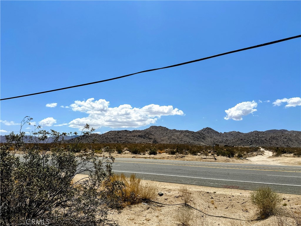 10 acres on the eastern edge of Joshua Tree. Highway frontage and spectacular desert views. Great investment opportunity! JT/RL-5 Zoning. Short drive to downtown shops, attractions, and amenities. 15 minutes from the Joshua Tree National Park entrance. Property does not have an assigned address - for listing purposes only. GPS: (34.1354097, -116.2016771) APN: 0608-141-04-0000