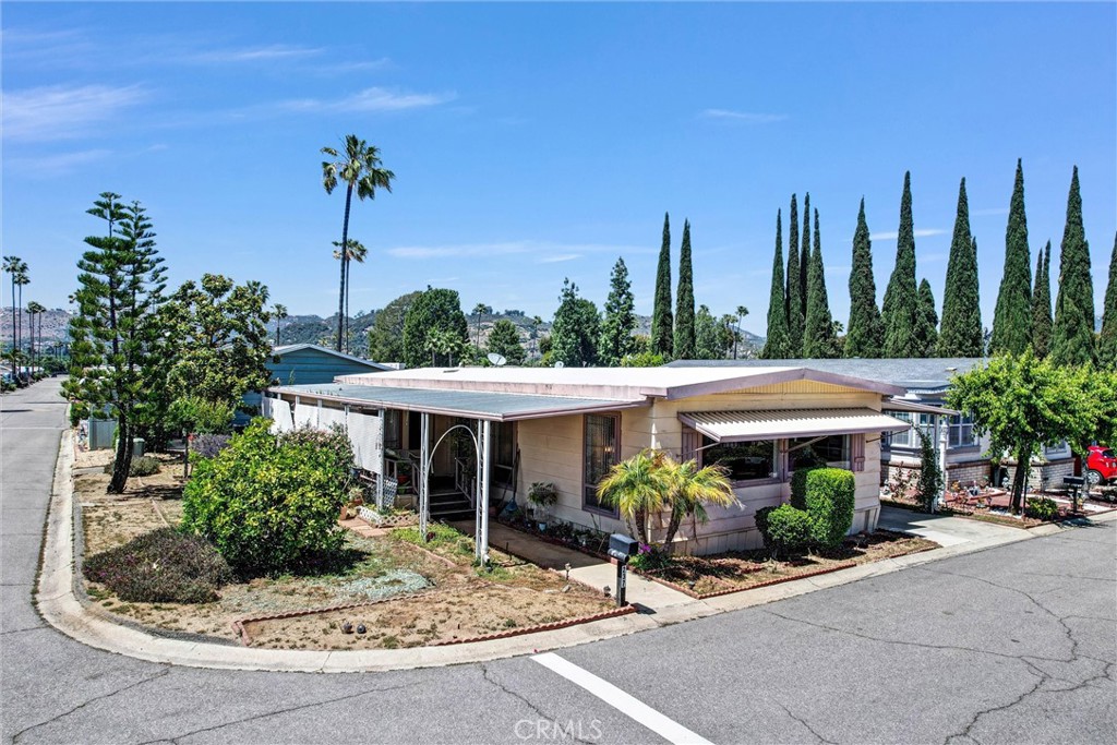 A must-see home in a vibrant 55+ community! Charming 2-bedroom, 2-bath mobile home offering 1,440 sq. ft. of comfortable living space on a spacious corner lot. Features include a formal dining room, living room, cozy family room, and a spacious enclosed patio with a laundry area. Located in a well-maintained mobile home park with two pools and jacuzzi, a recreational room, fun community activities, pet-friendly policies, and plenty of guest parking. Conveniently close to shopping, grocery stores, and public transportation. The $660/month land lease includes water and trash services, making this a fantastic and affordable opportunity to enjoy comfortable living with great amenities.