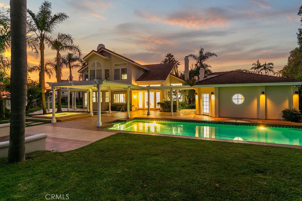 Perched on a 19000+ square foot level ocean view lot in gated Harbor Pointe, is your next home! With Mediterranean vibes and only 20 homes in the subdivision, you have the advantage of privacy and space, yet closeness to the financial headquarters, prestigious shopping and world class restaurants of Newport's Fashion Island. Great indoor/outdoor living with 3 grassy areas, a giant pool with separate spa...it's a welcoming space for gathering friends and family as well as a peaceful retreat to enjoy both the early coastal fog and the sunset over the ocean. The permitted pool house with its bedroom, kitchen, bath and sauna might be perfect as a home for your guests or family members. All bedrooms are ensuite. Vaulted ceilings in living room and upstairs bedrooms, living and dining rooms accentuate light and grand space. There is a spacious downstairs bedroom suite.You'll love your sanctuary/primary retreat with its corner fireplace, its 2 story windows, and its secluded ocean view balcony. And check out the separate office with its 2 story sun lit windows and extensive work area...what a great place to show-off your special awards and trophies.